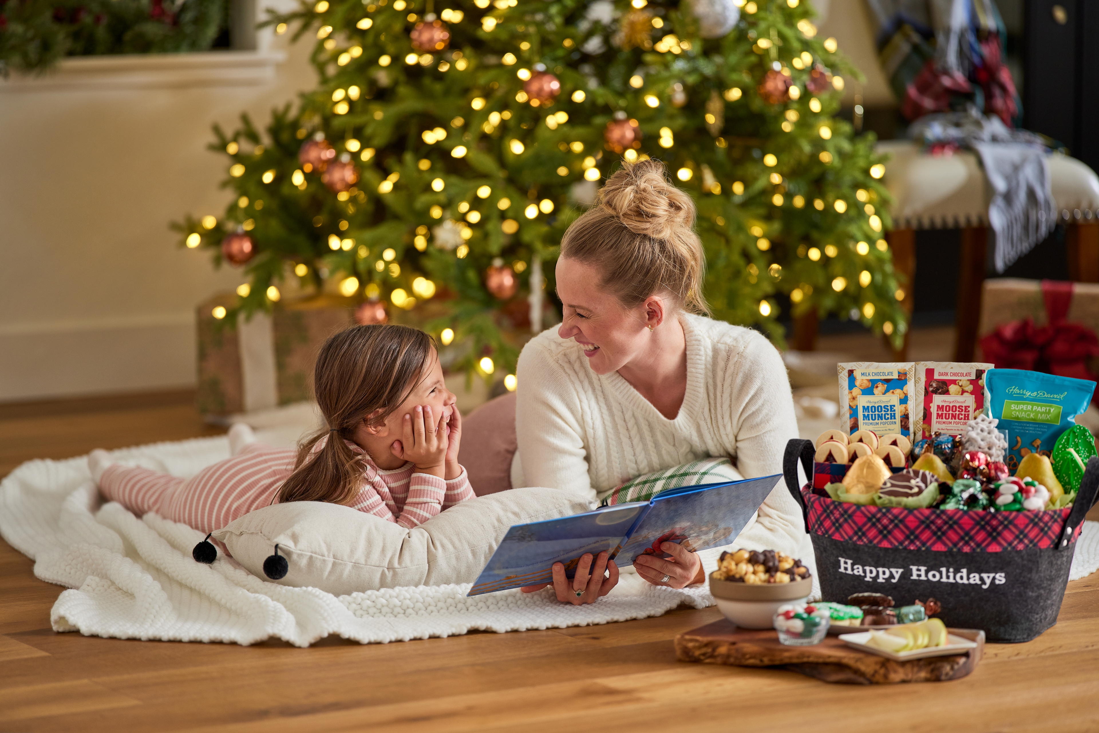 Woman reading a book to young girl on Christmas eve.