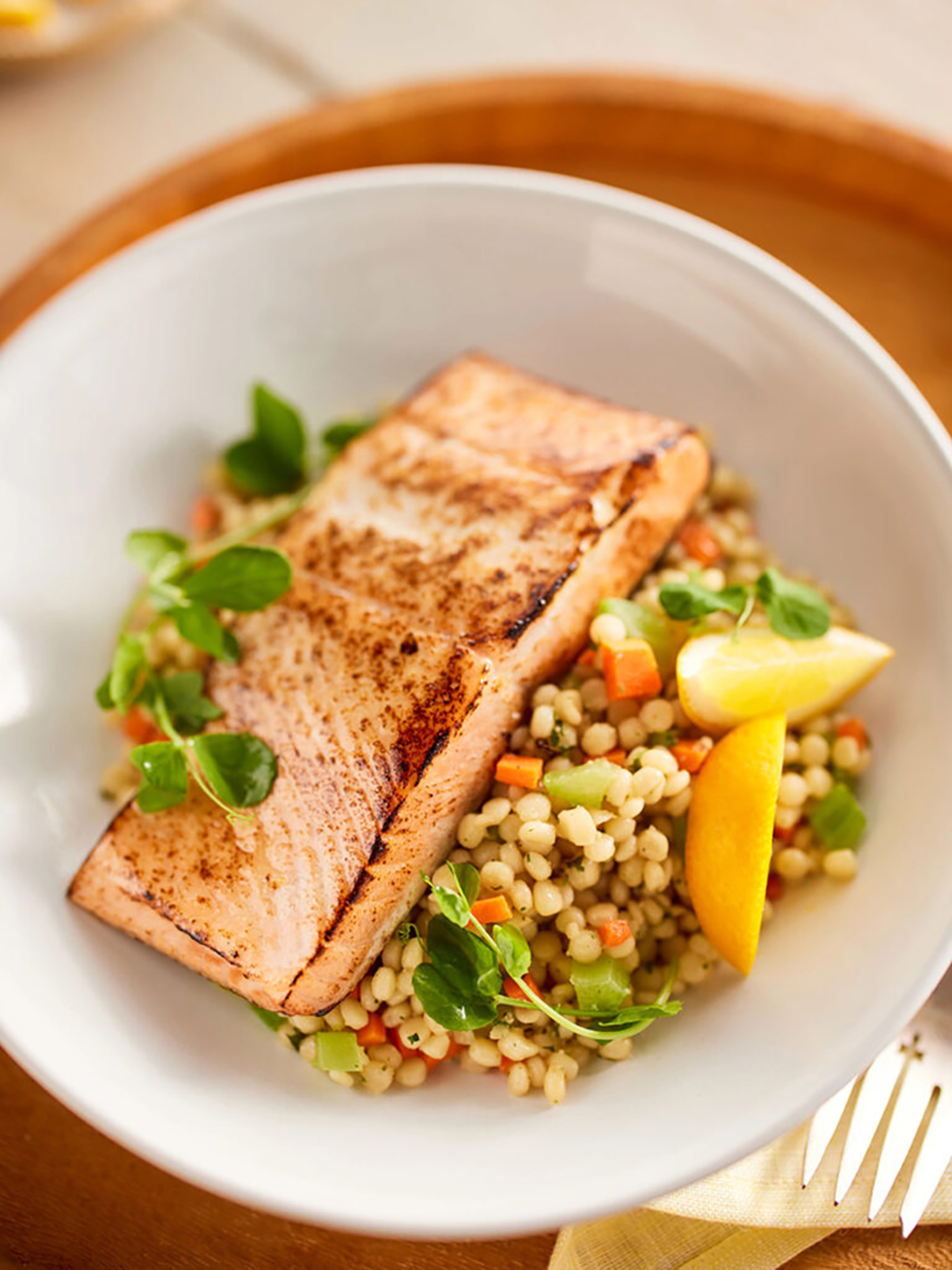 Omega salmon in a bowl with rice and vegetables.