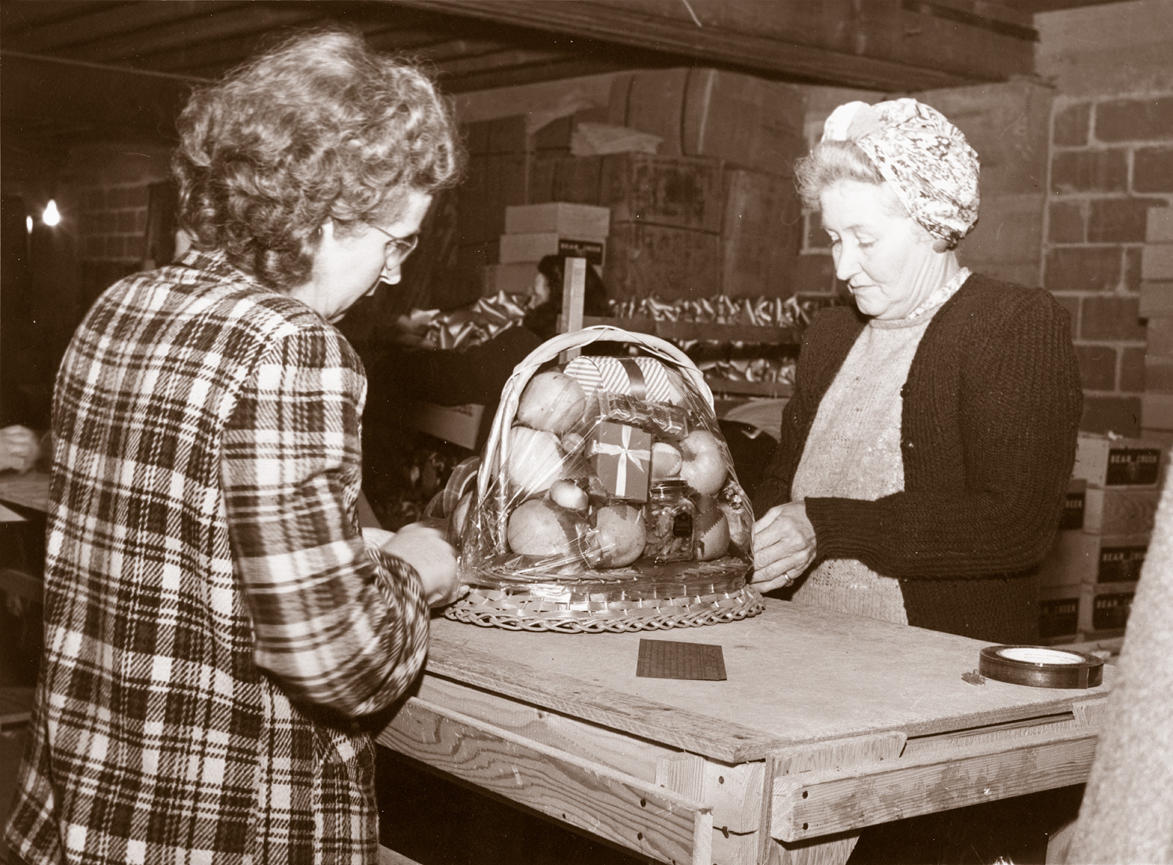 Women finishing a gift basket from Harry & David