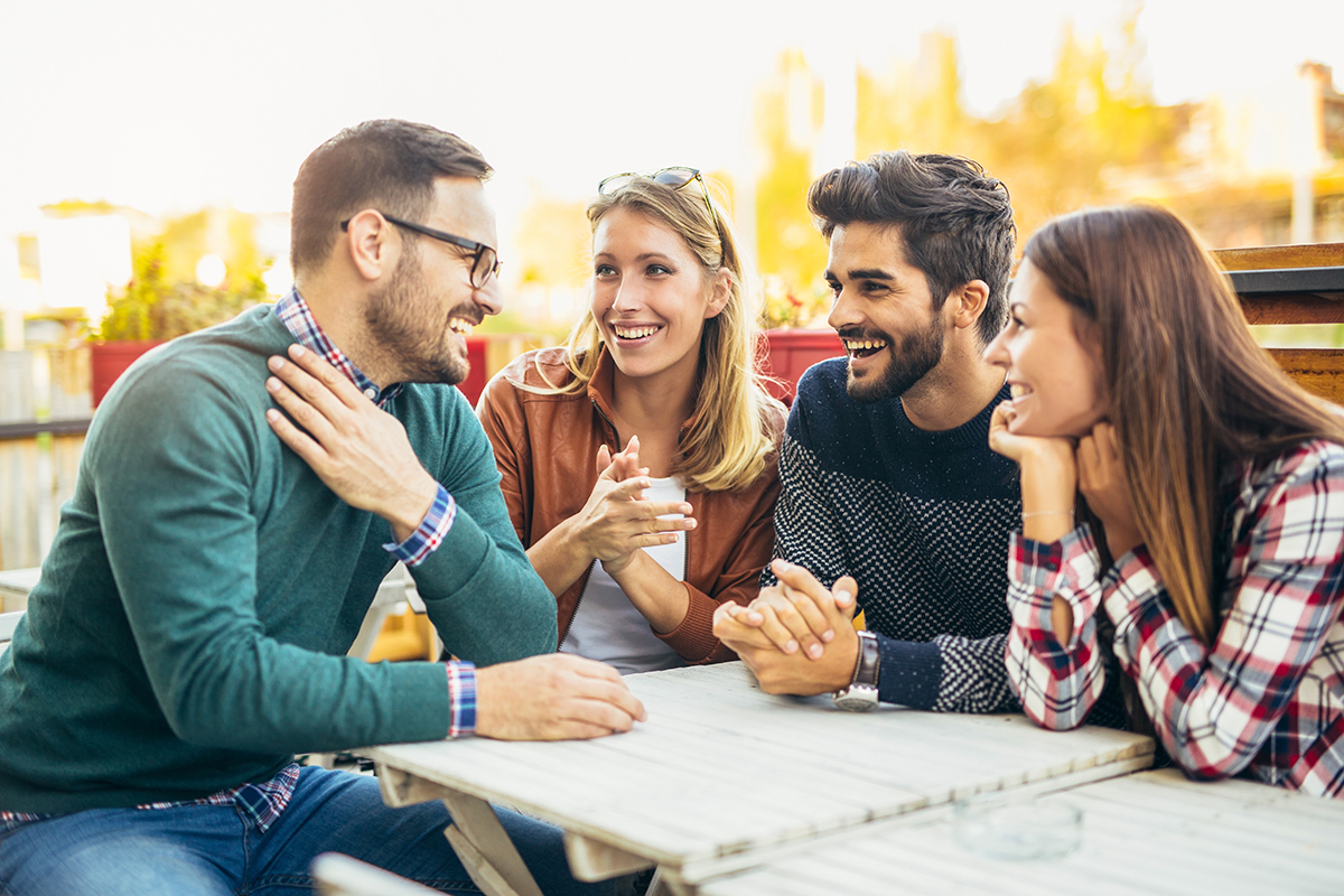 Article Cards Featured Image Group of four friends having fun a coffee together. Two women an