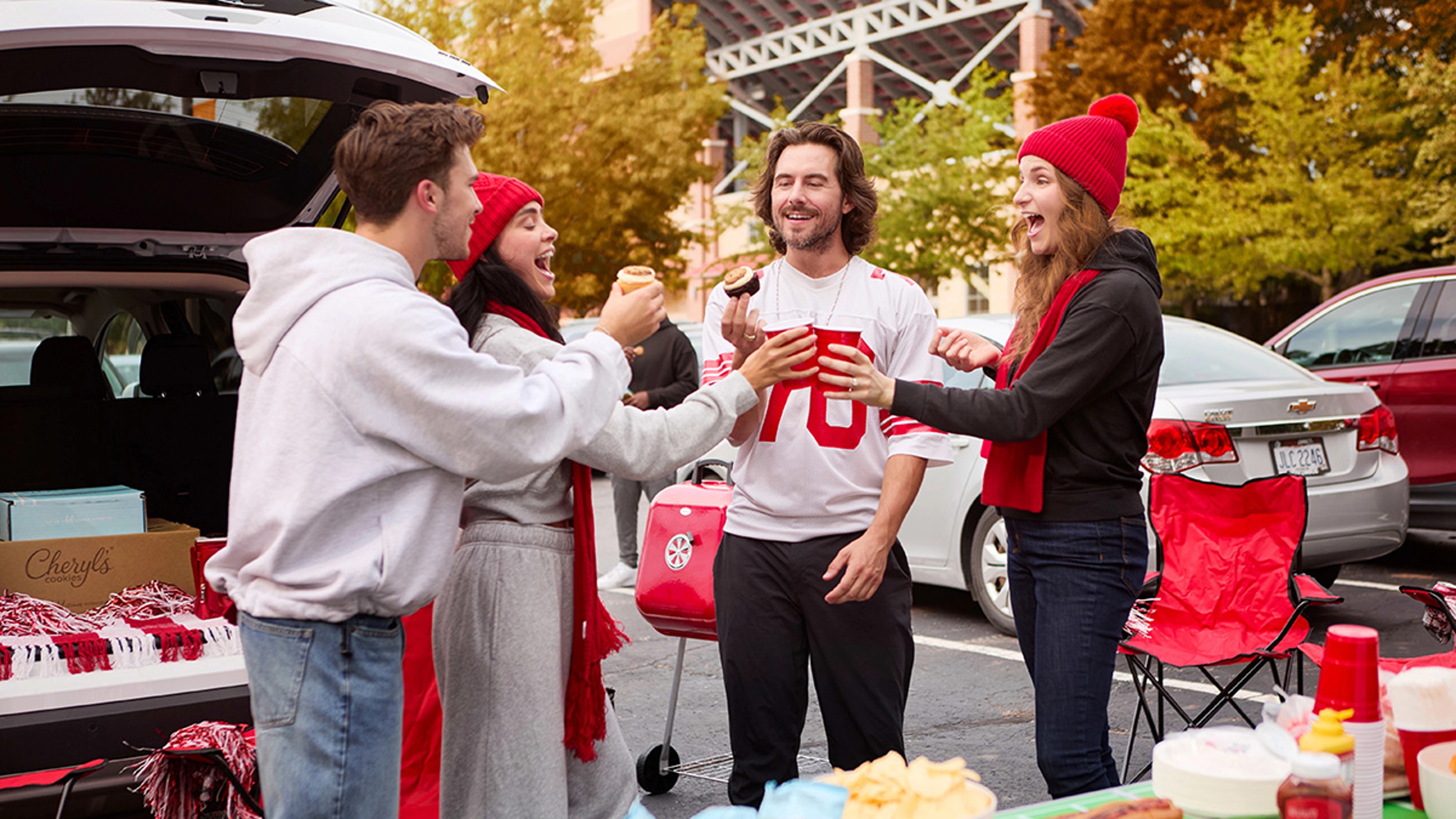 Group doing a tailgate with food.
