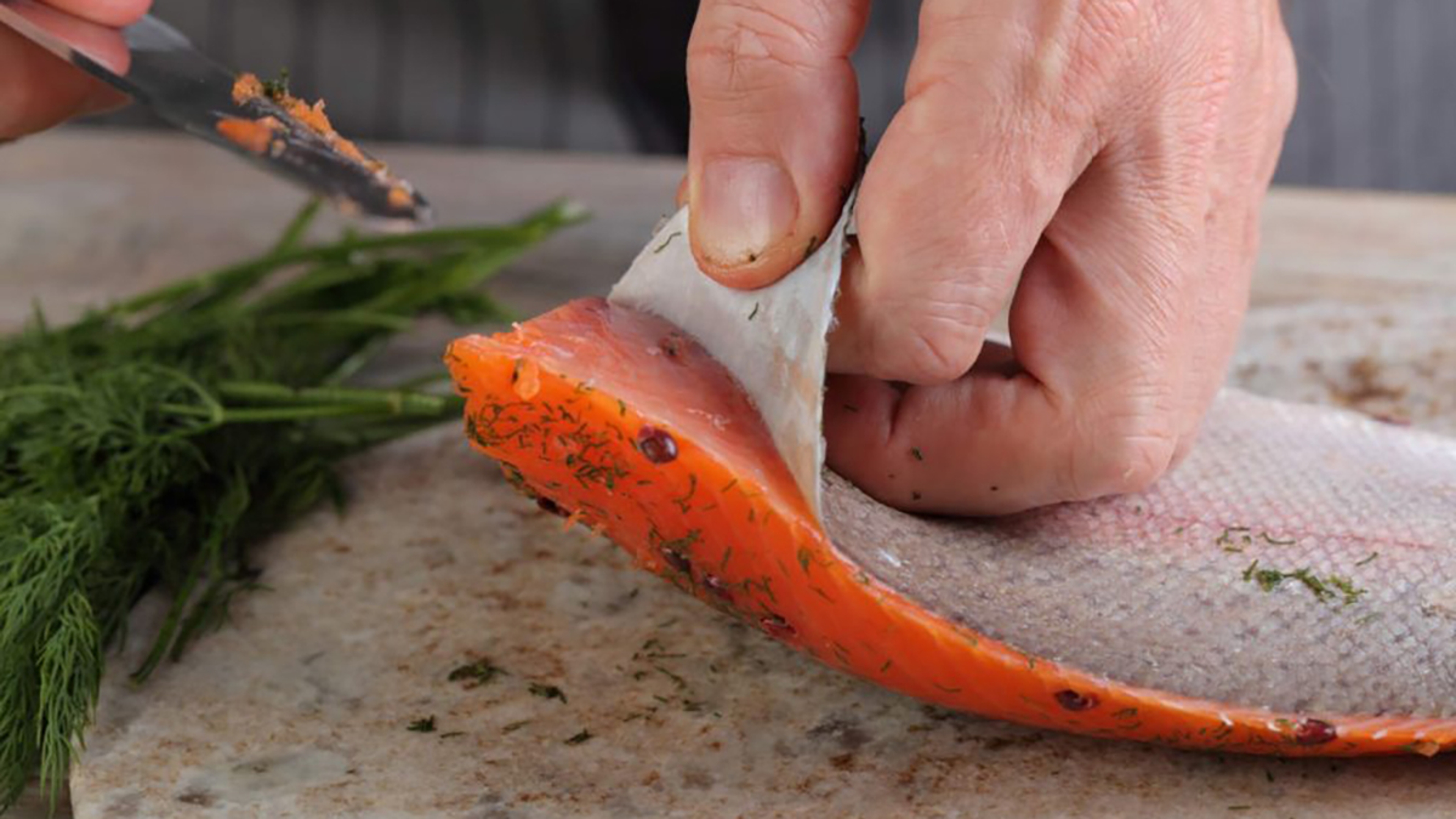 Salmon skin being removed.