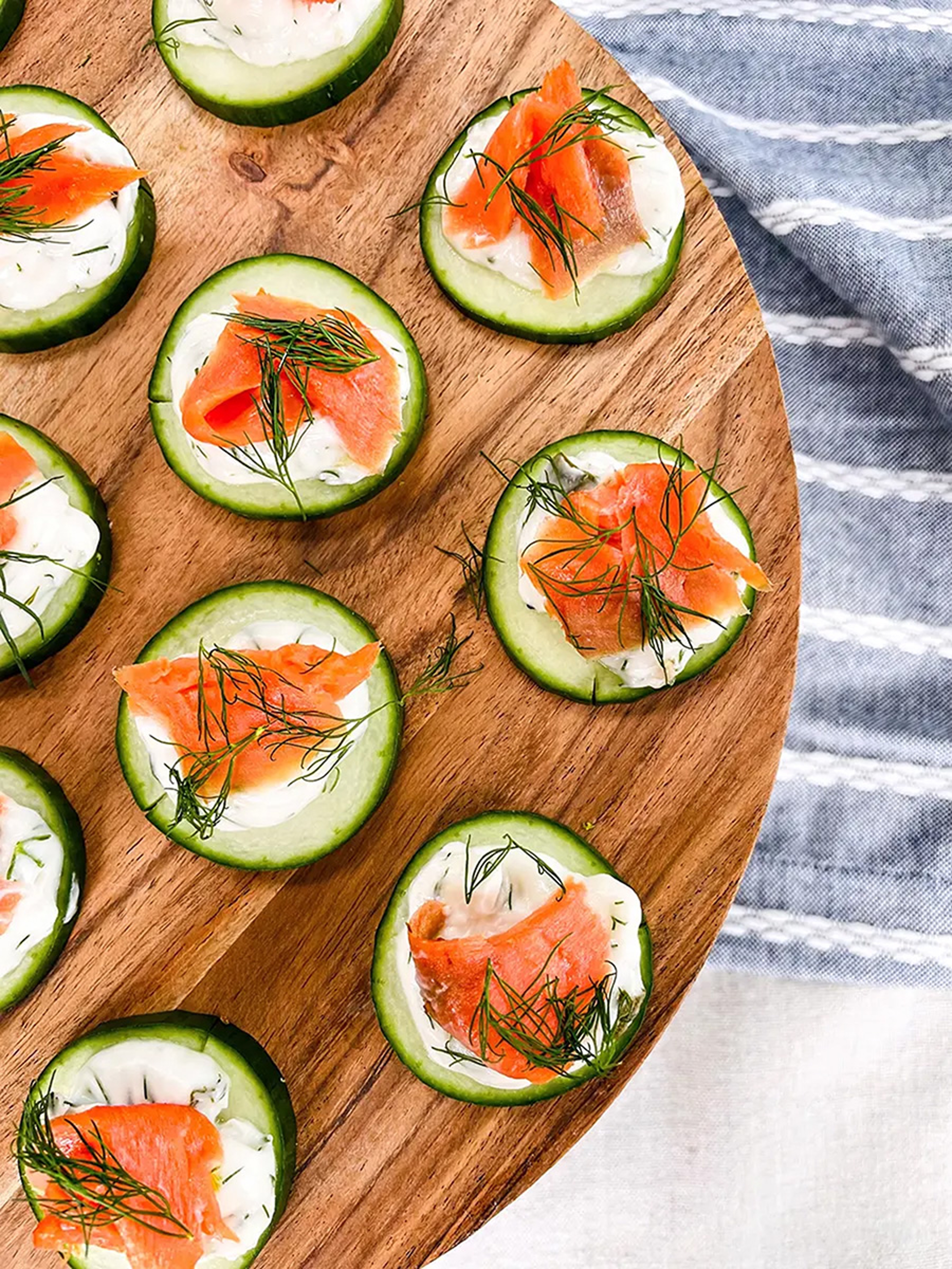 Cutting board topped with cucumber appetizers for Labor Day.