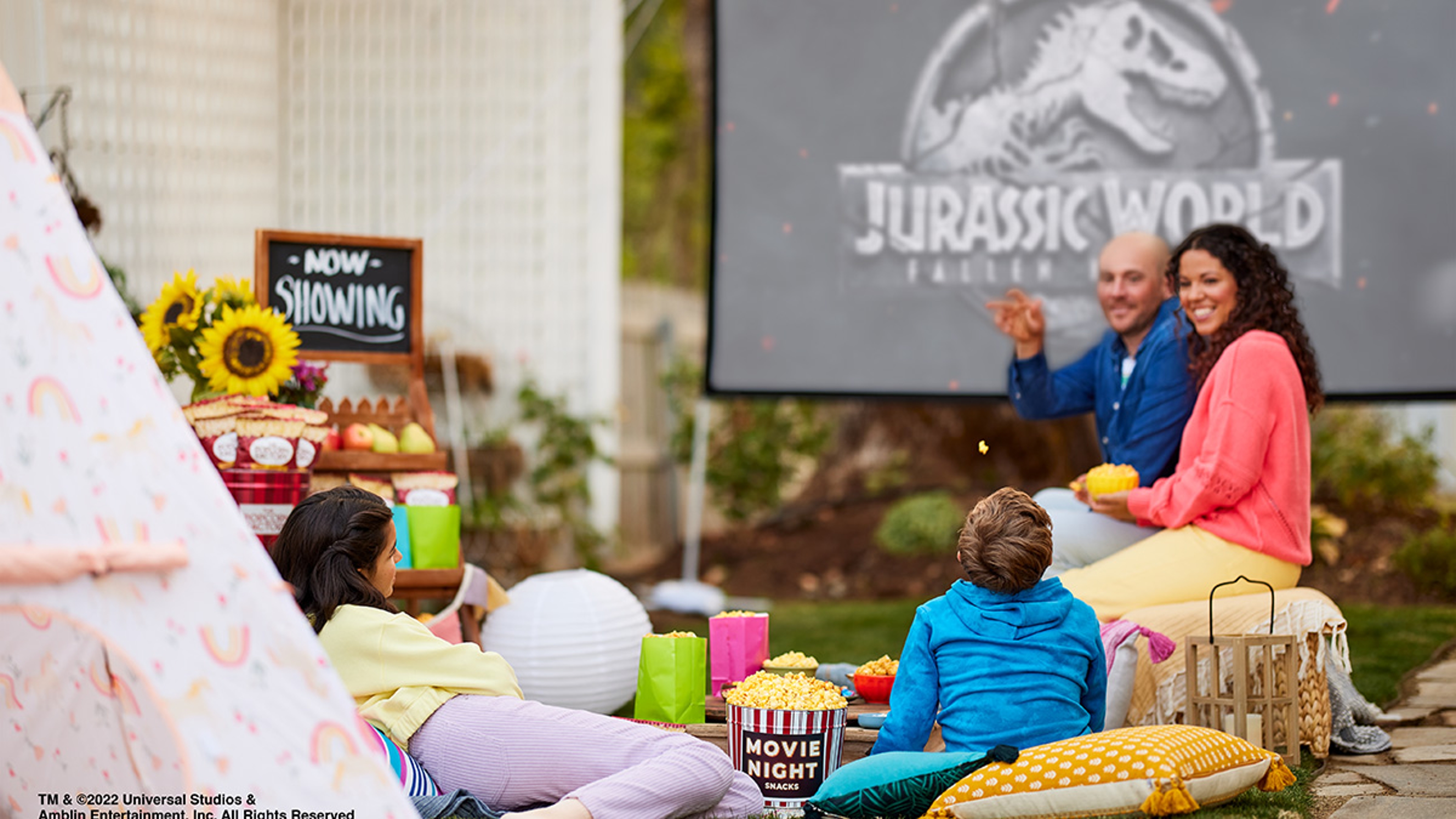 Outdoor movie night with popcorn and snacks.