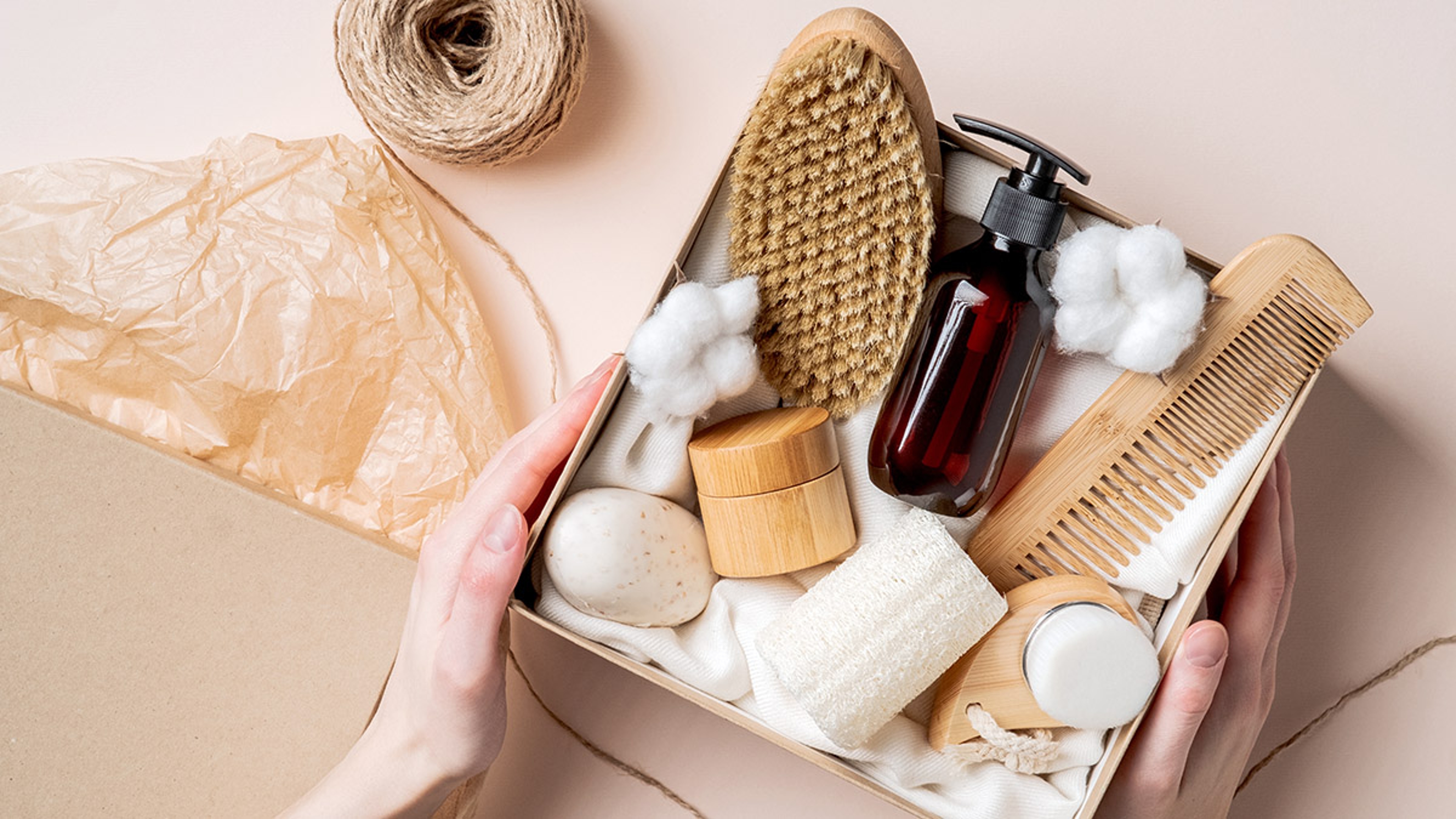 person who is hard to shop for: Beauty subscription Box preparation. Female hands holding gift b