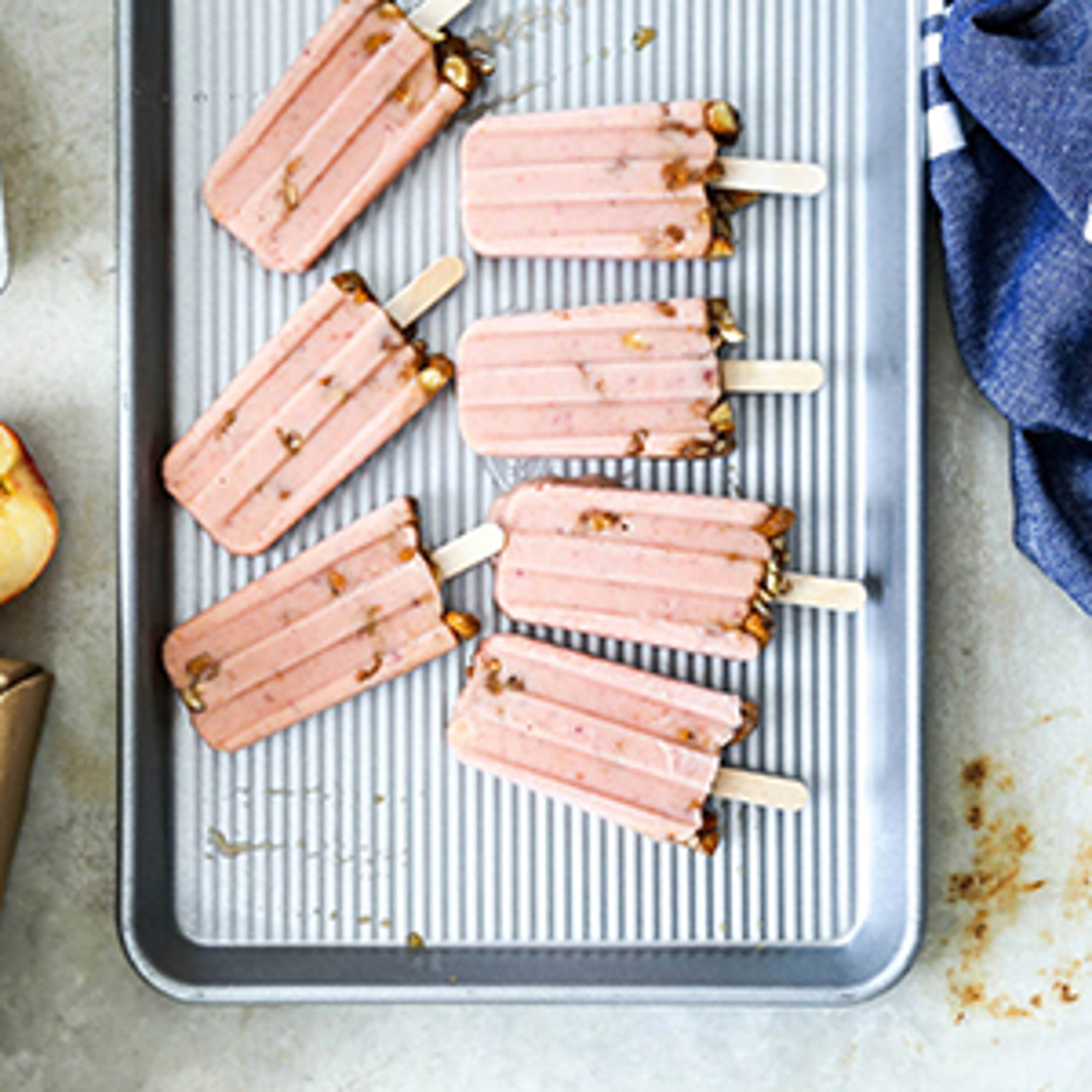 Fruit popsicles on a cookie sheet.