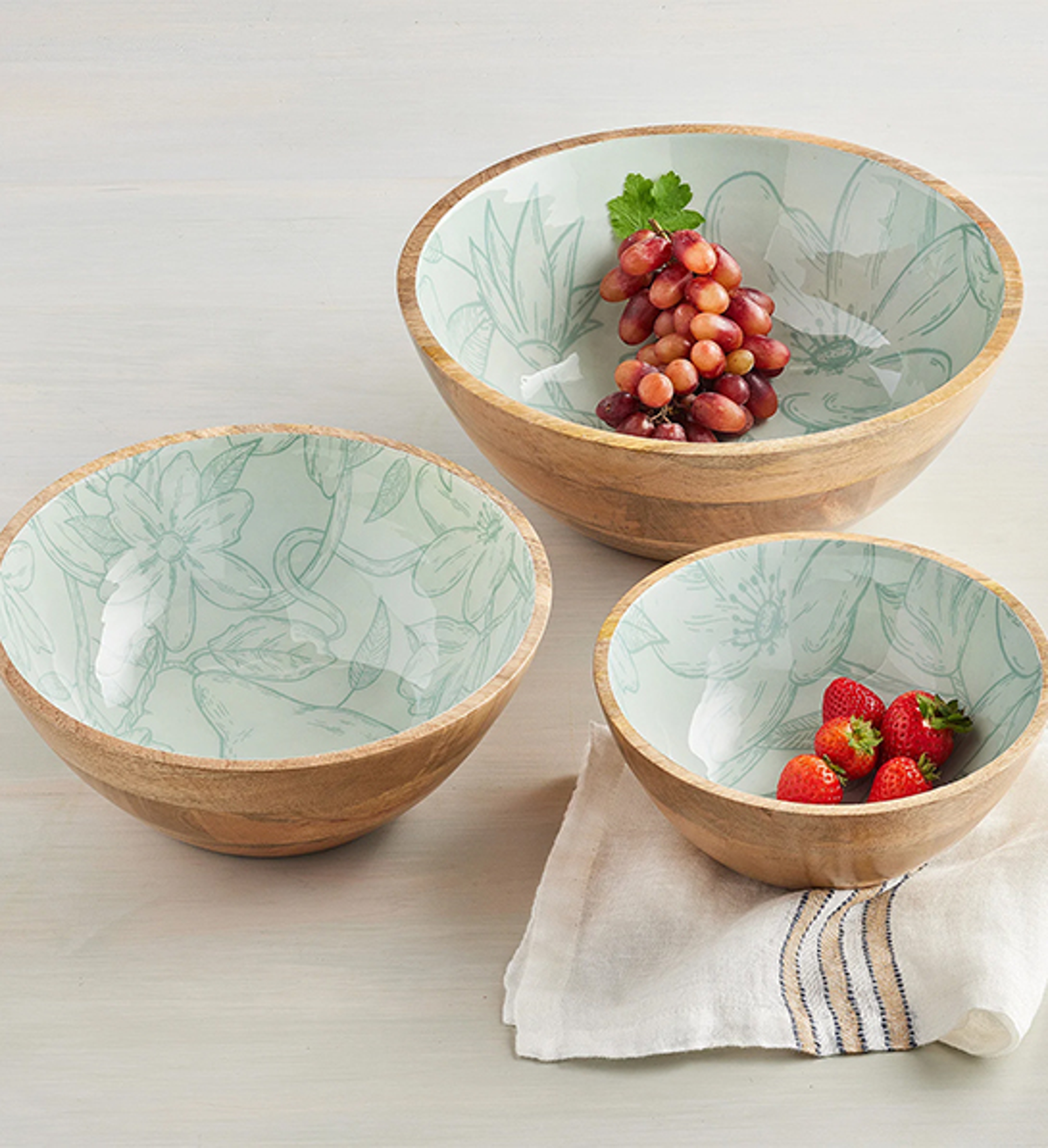 Several bowls of different sizes containing fruit.