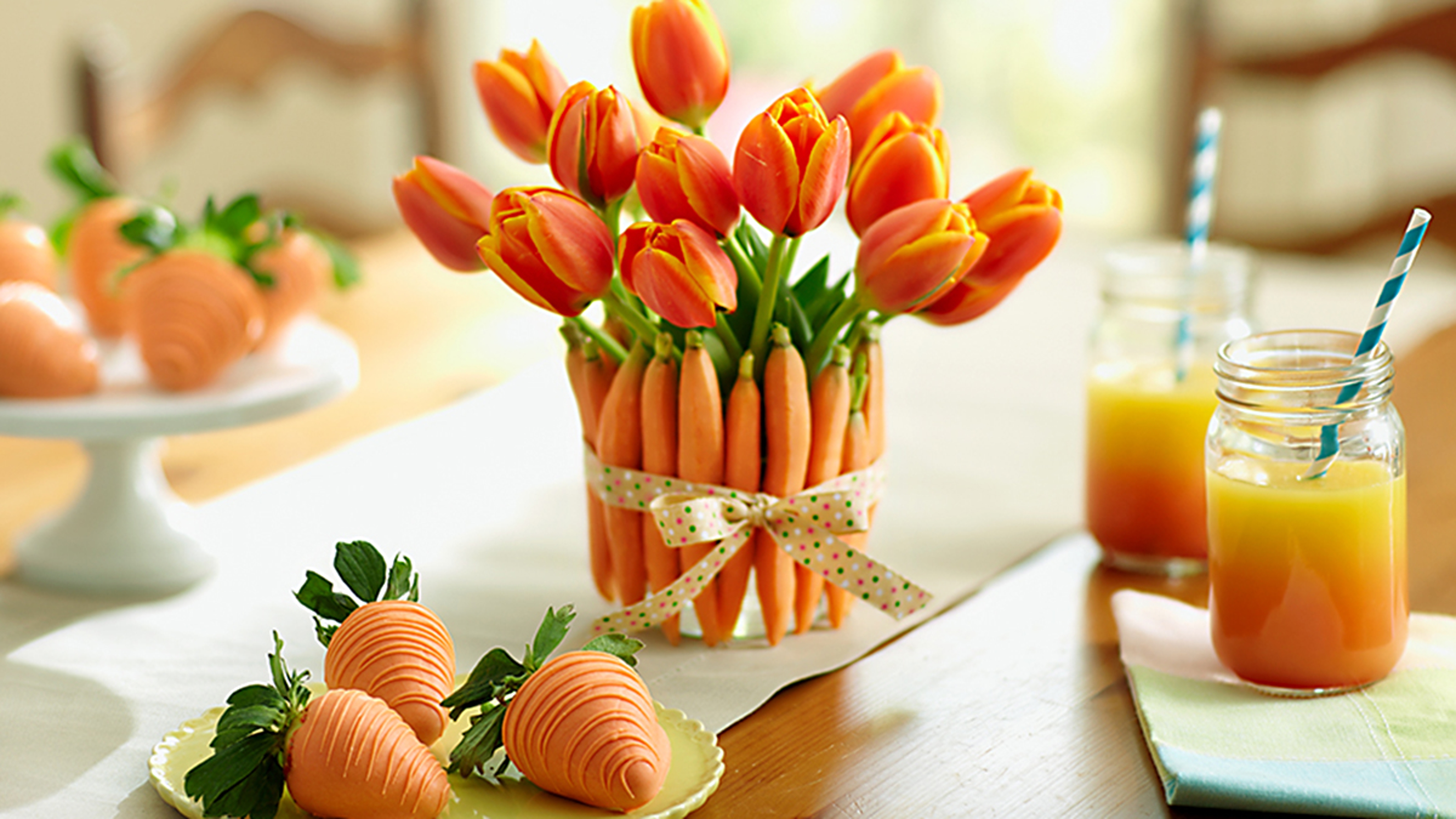 Article Cards Featured Image Vase made of carrots with ribbon around it holding orange tulips