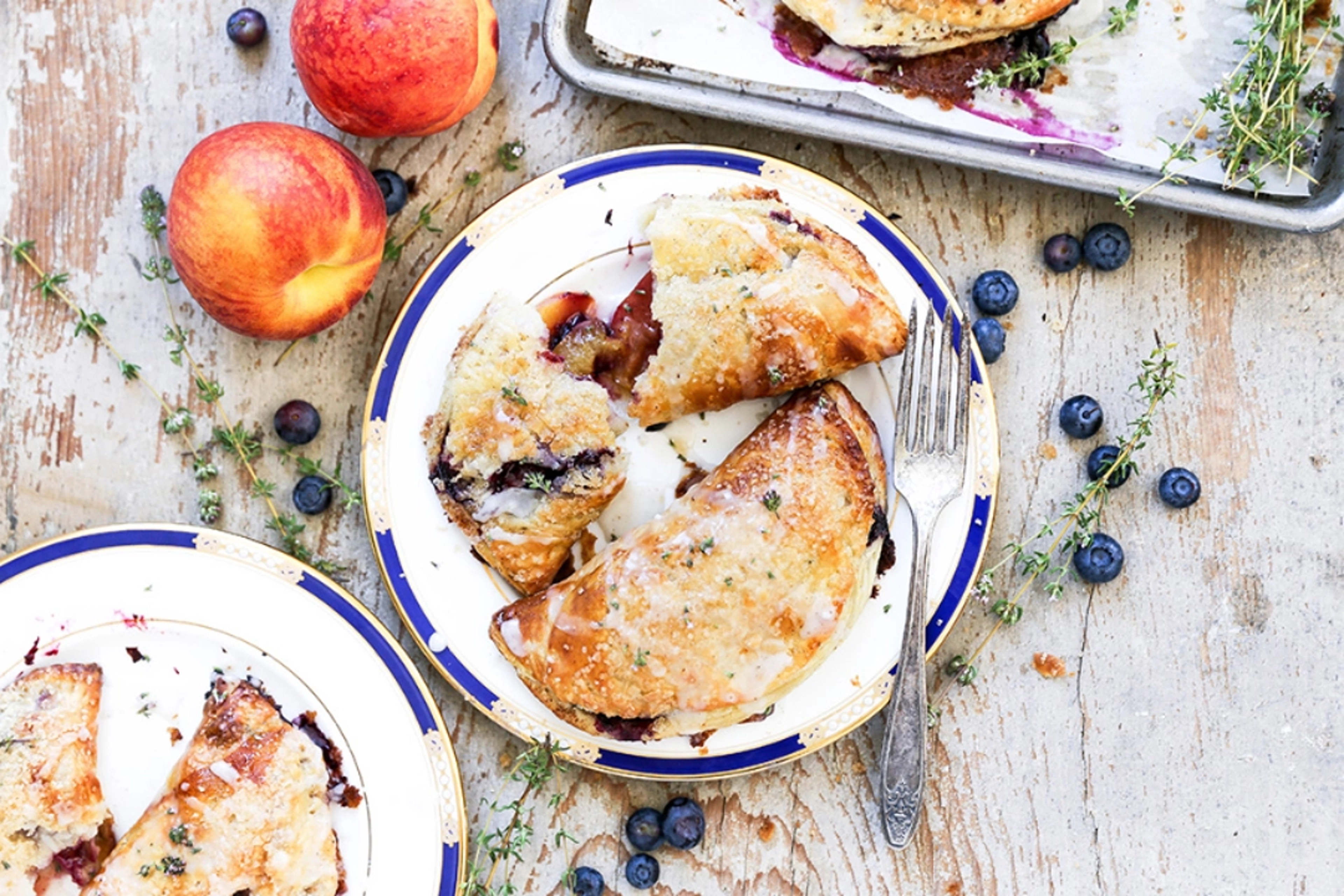 Blueberry peach hand pies on a plate.