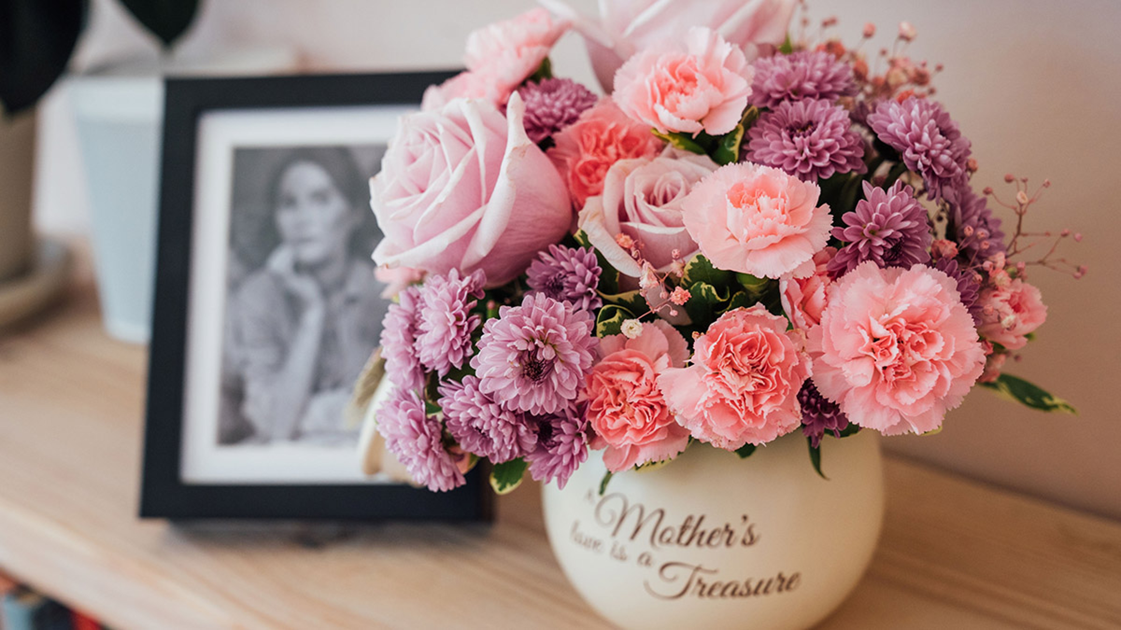 History of mothers day with mothers day flowers and black and white photo of mother