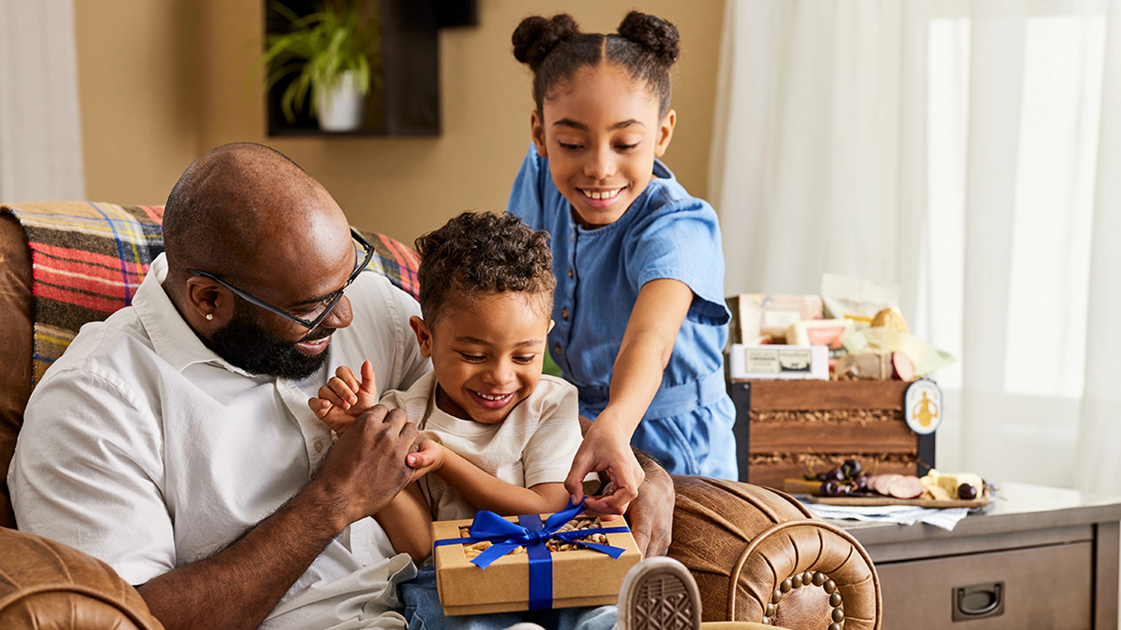 A photo of gift history with a family opening a gift