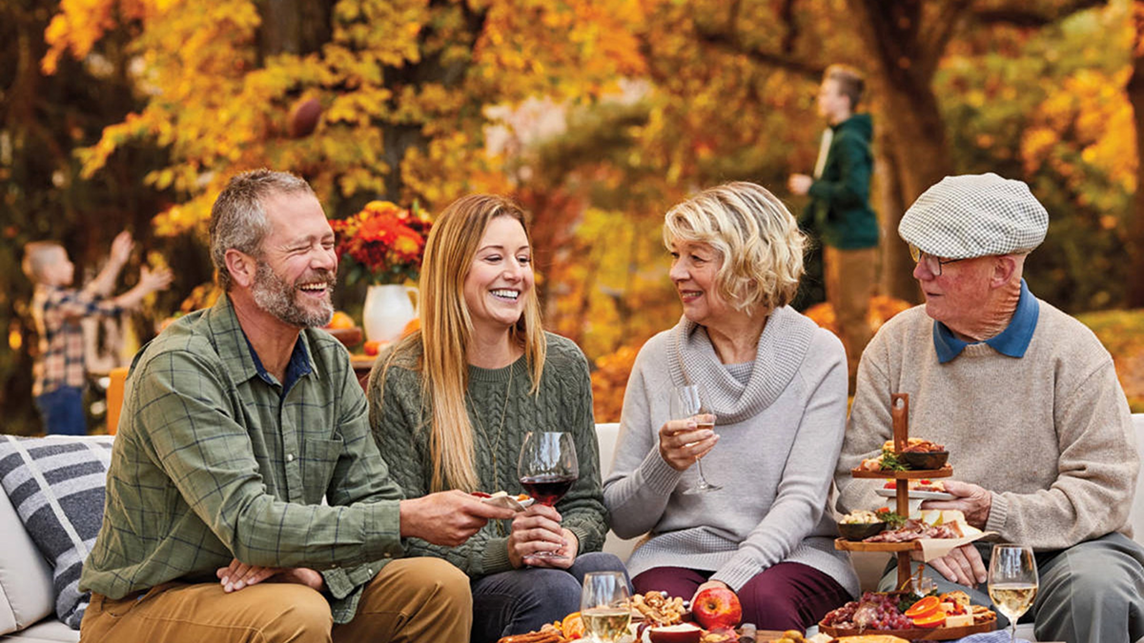 Group celebrating an October birthday outside.