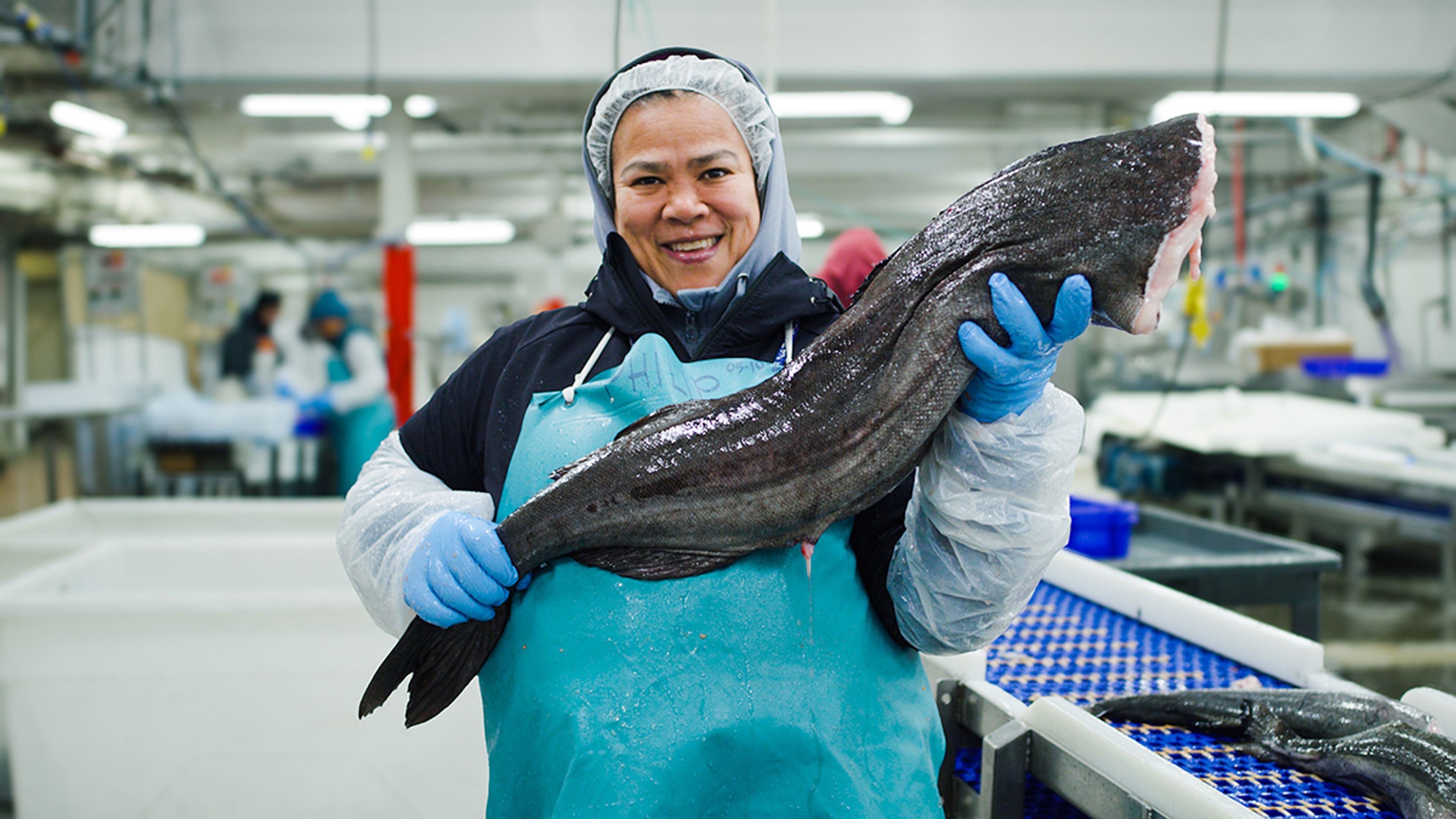 Copper River Seafoods processor holding a sablefish.