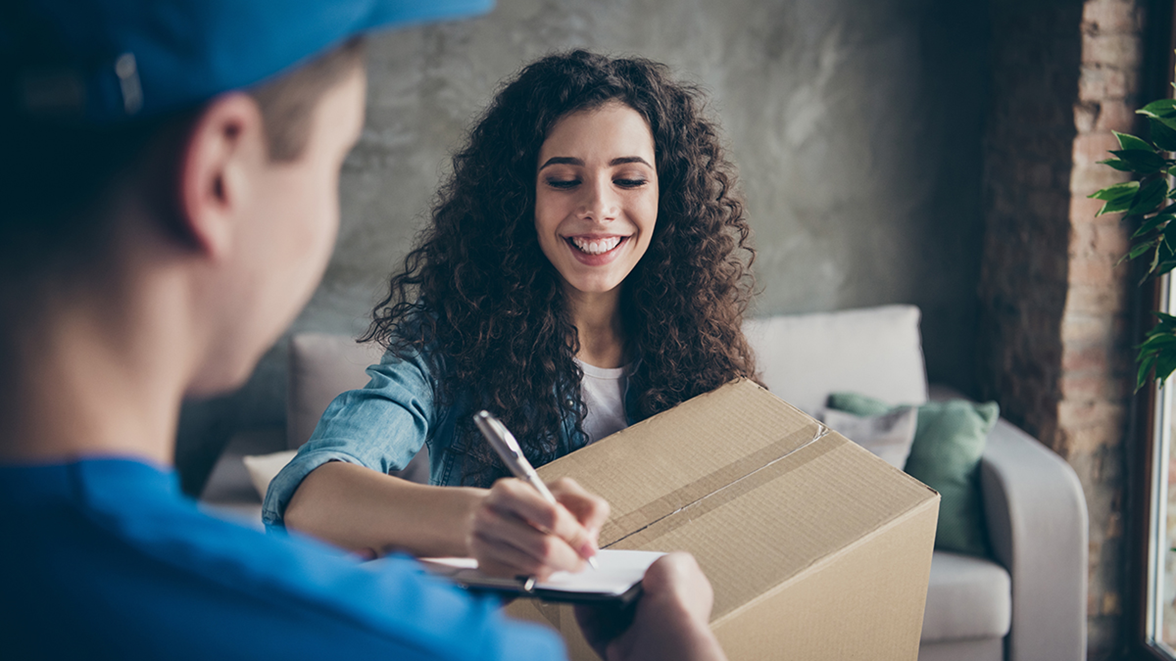 Article Cards Featured Image Portrait of nice attractive charming lovely cheerful cheery wavy haired girl receiving new gift present surprise clothes buying shop online signing document at modern loft industrial style interior