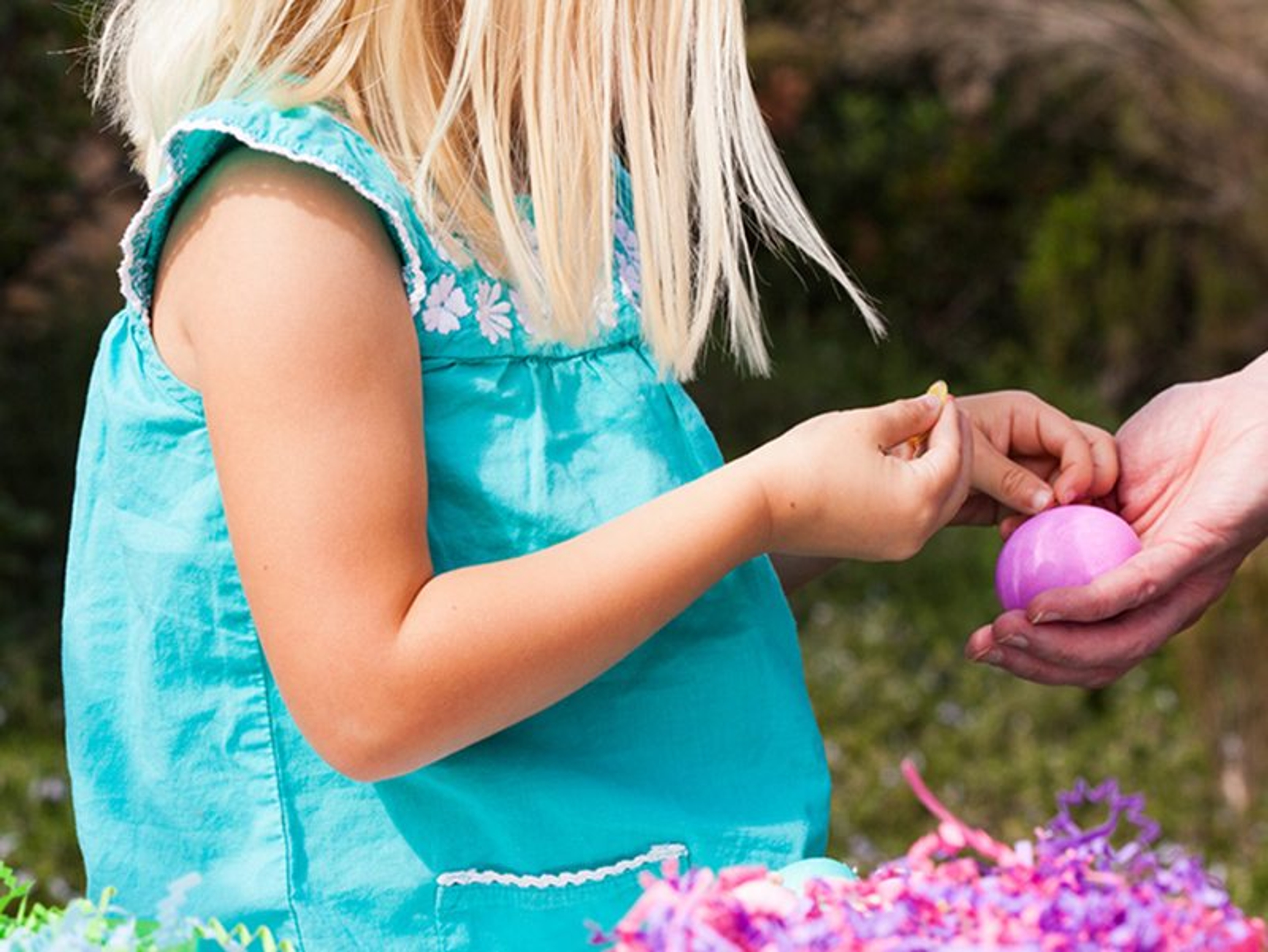 Easter Egg Decorating Party Parent helping little one with decorating easter egg