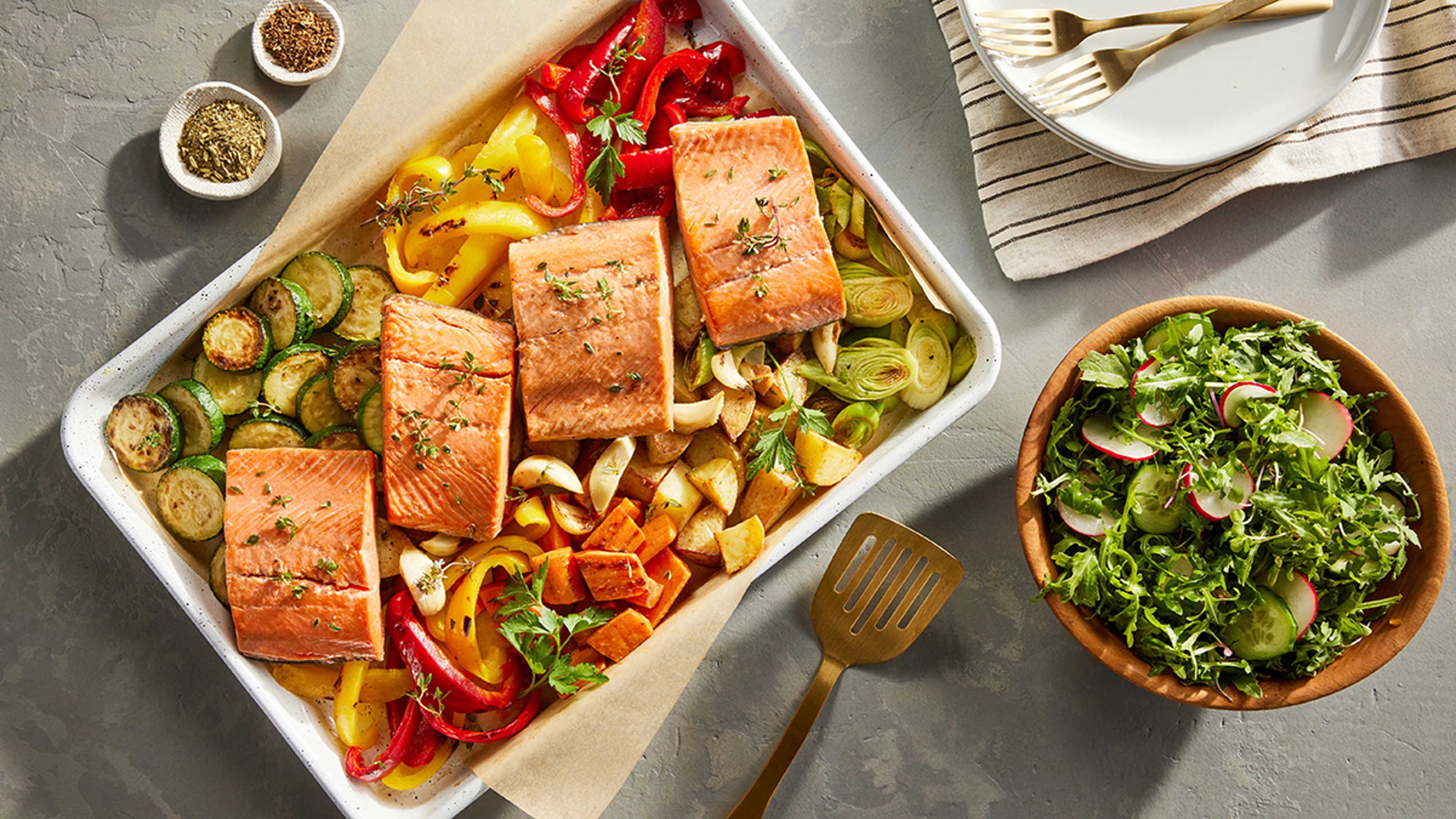 Copper River sockeye filets on a platter with roasted vegetables.