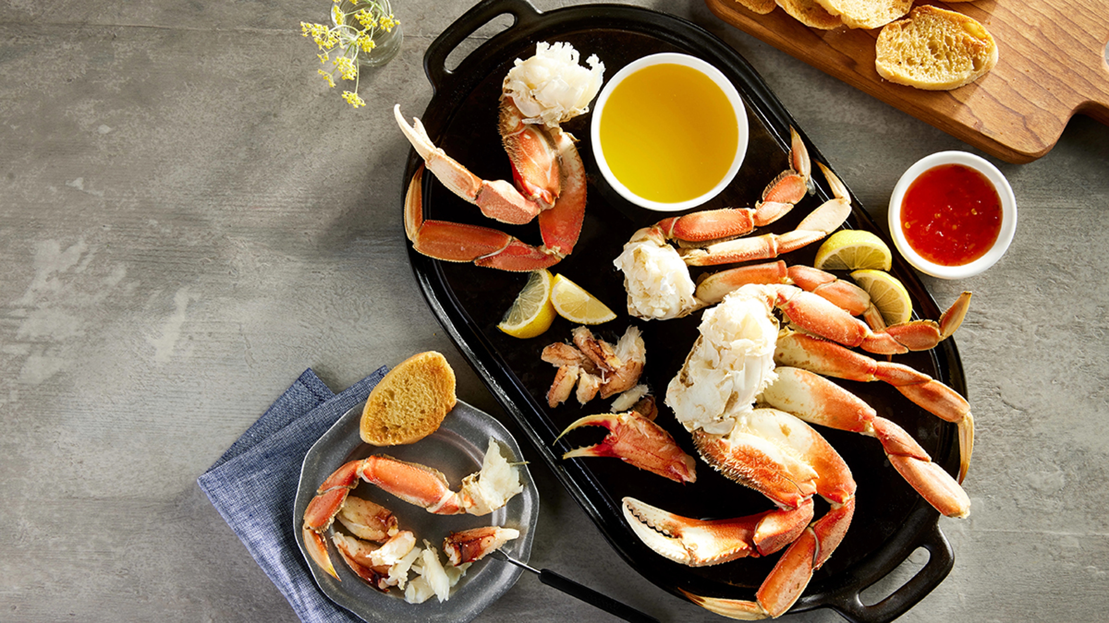 Crab on a platter with butter and other sauces.