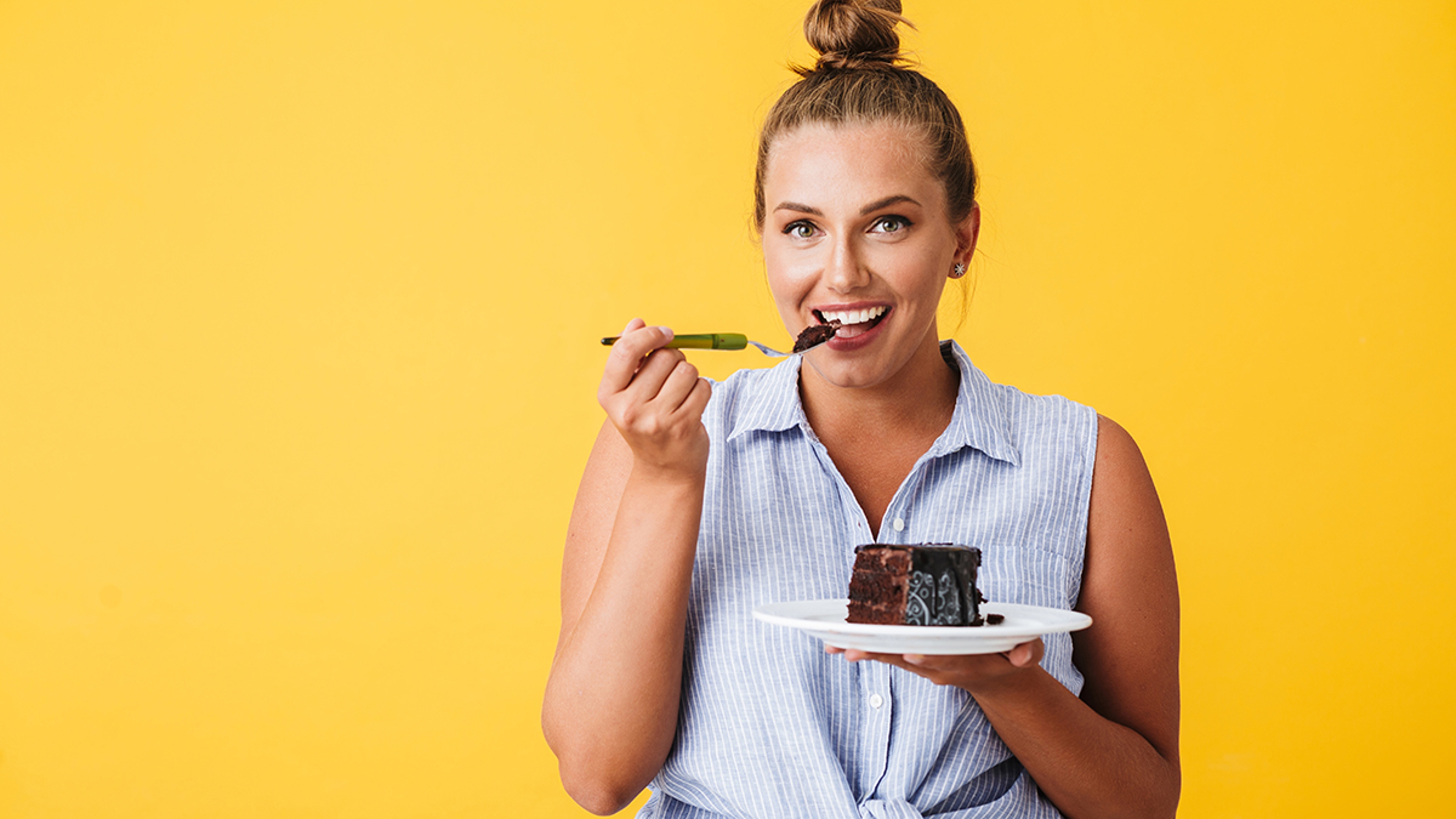 Article Cards Featured Image Young smiling woman in shirt happily looking in camera while eat