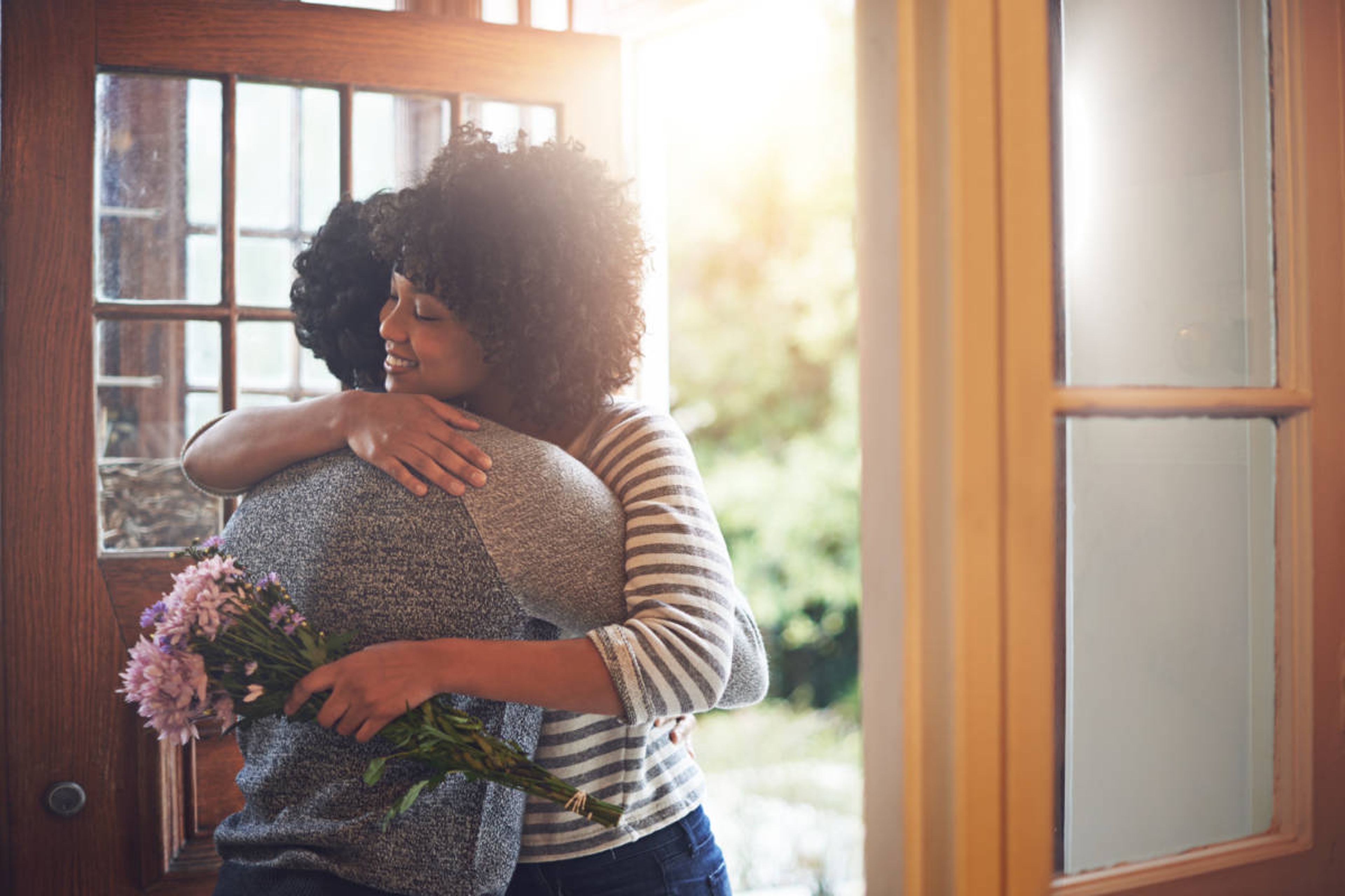 Article Cards Featured Image A young woman hugging her husband after receiving flowers from himhttp:// . . . /DATA/i collage/pu/shoots/