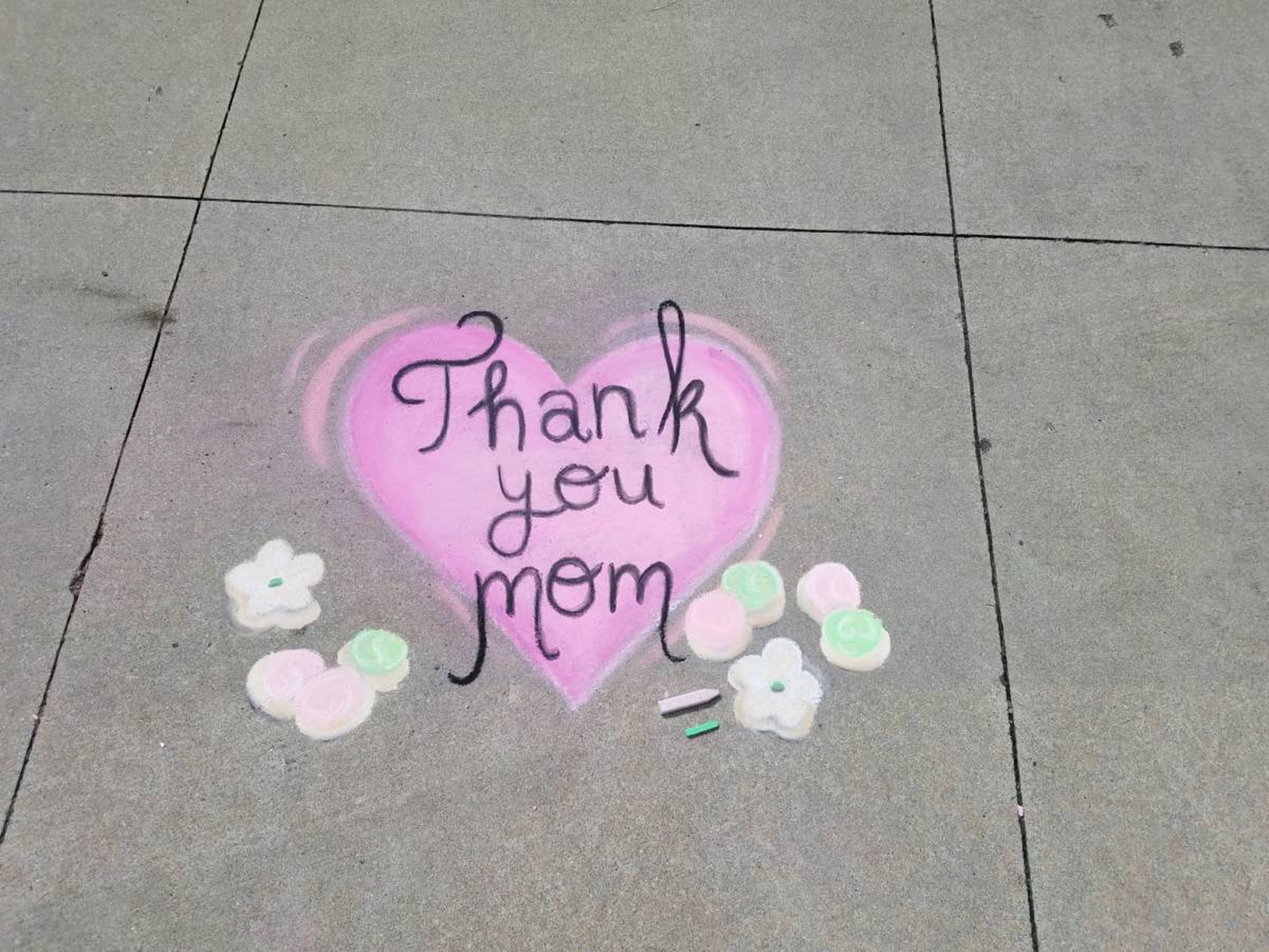 Thank You Mom in a heart written in chalk on the sidewalk