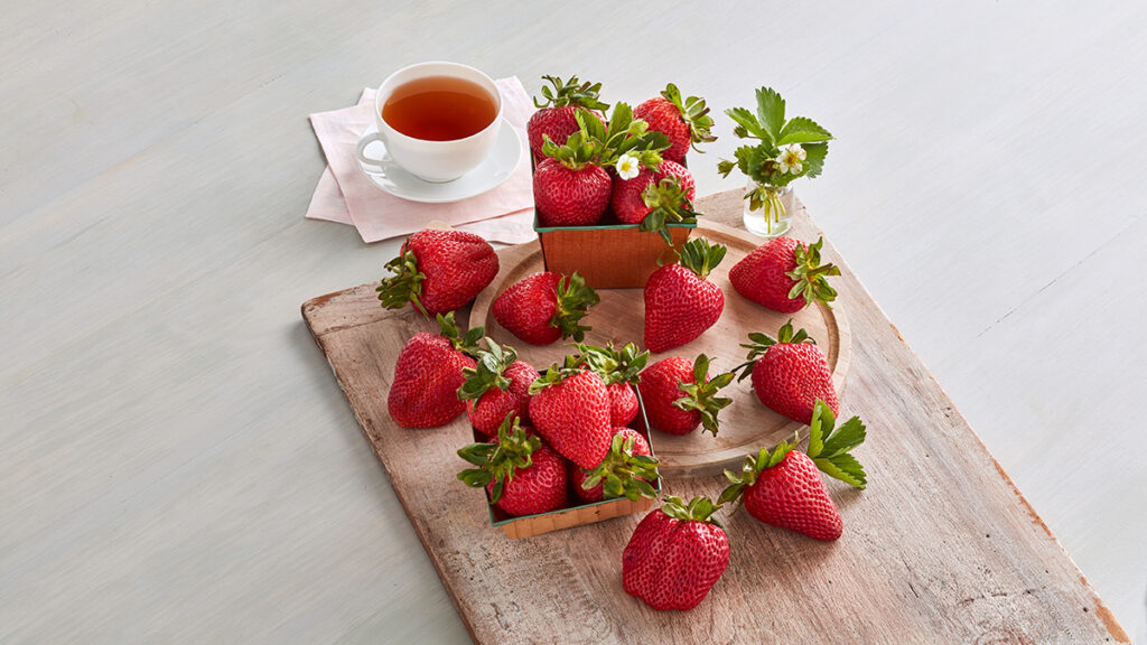 types of strawberries strawberries on a board with cup of tea