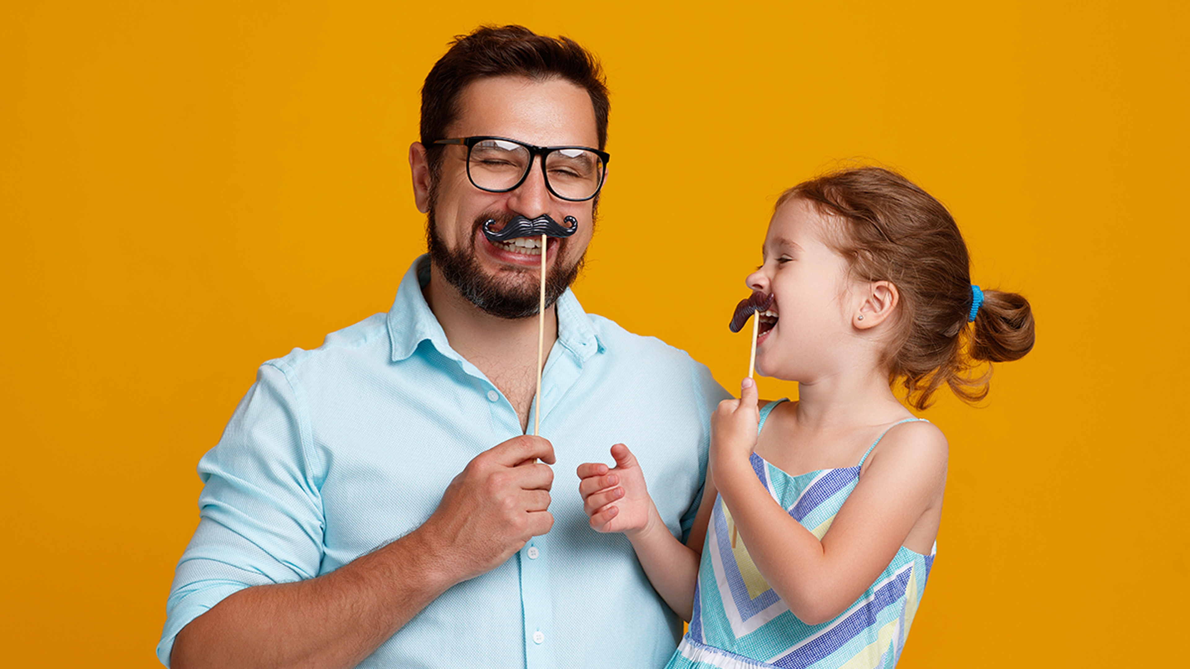 Article Cards Featured Image happy father's day! funny dad and daughter with mustache fooling around on yellow background