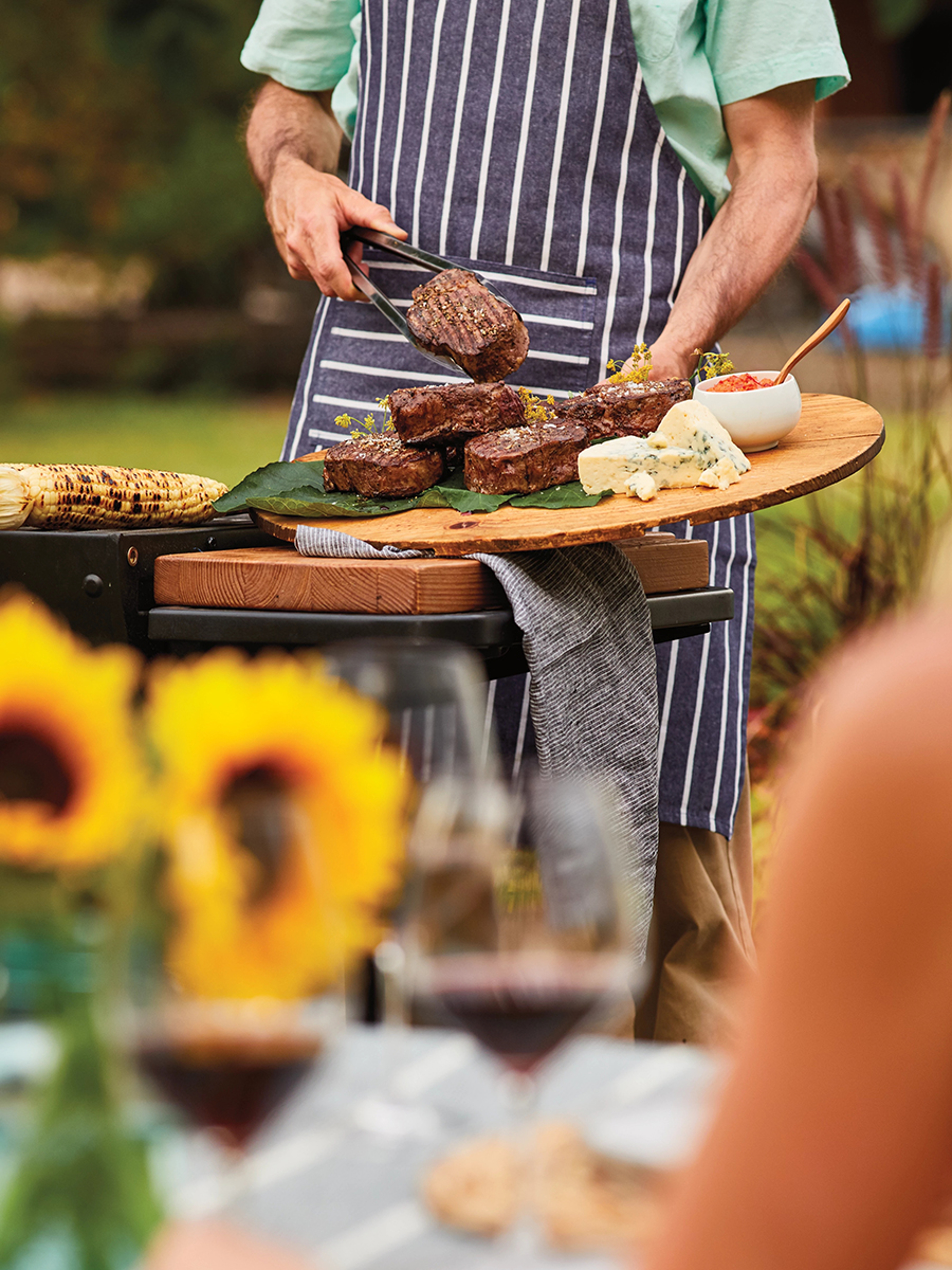summer grilling man standing behind a grill