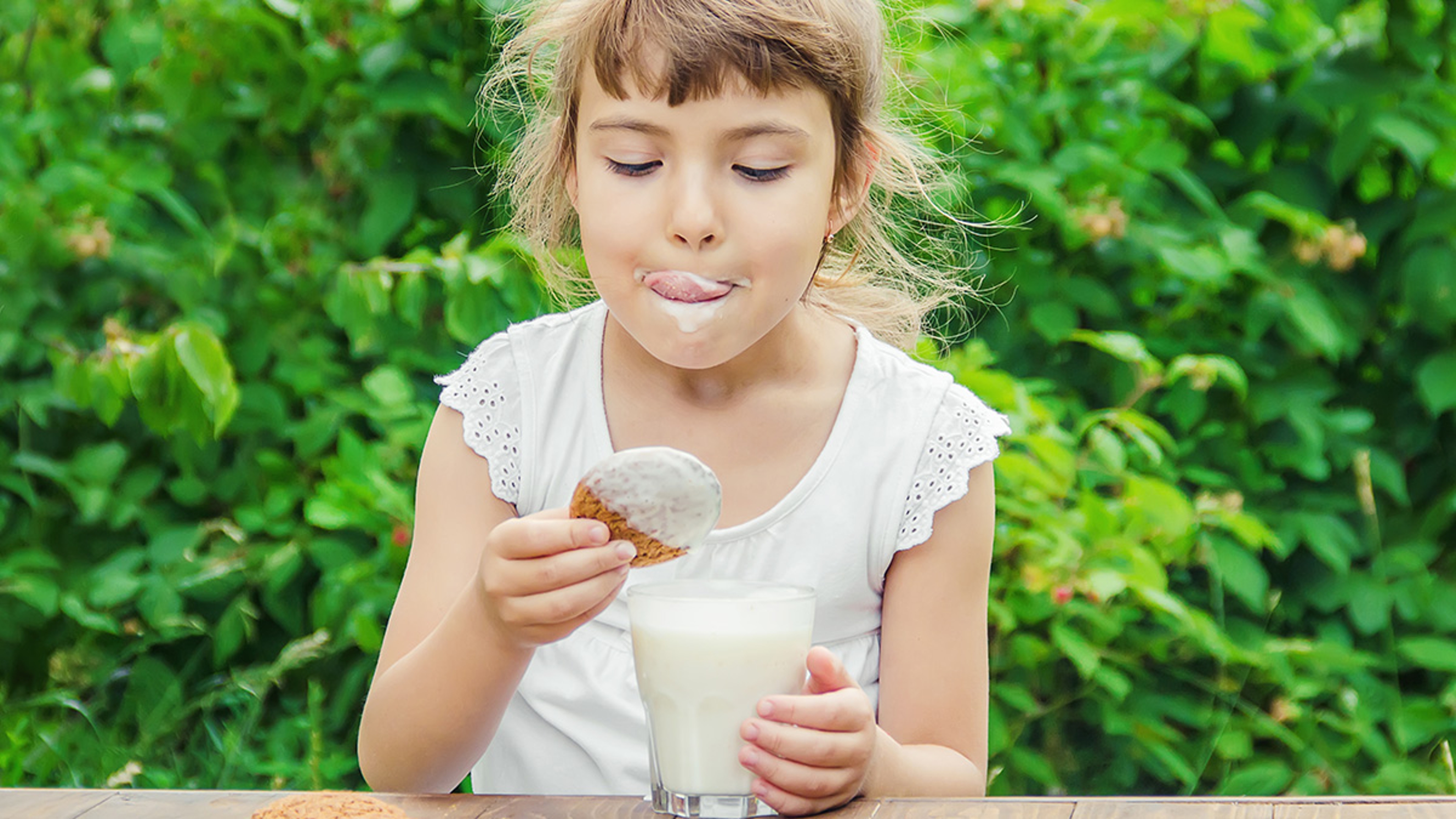 Article Cards Featured Image girl dipping cookies in milk