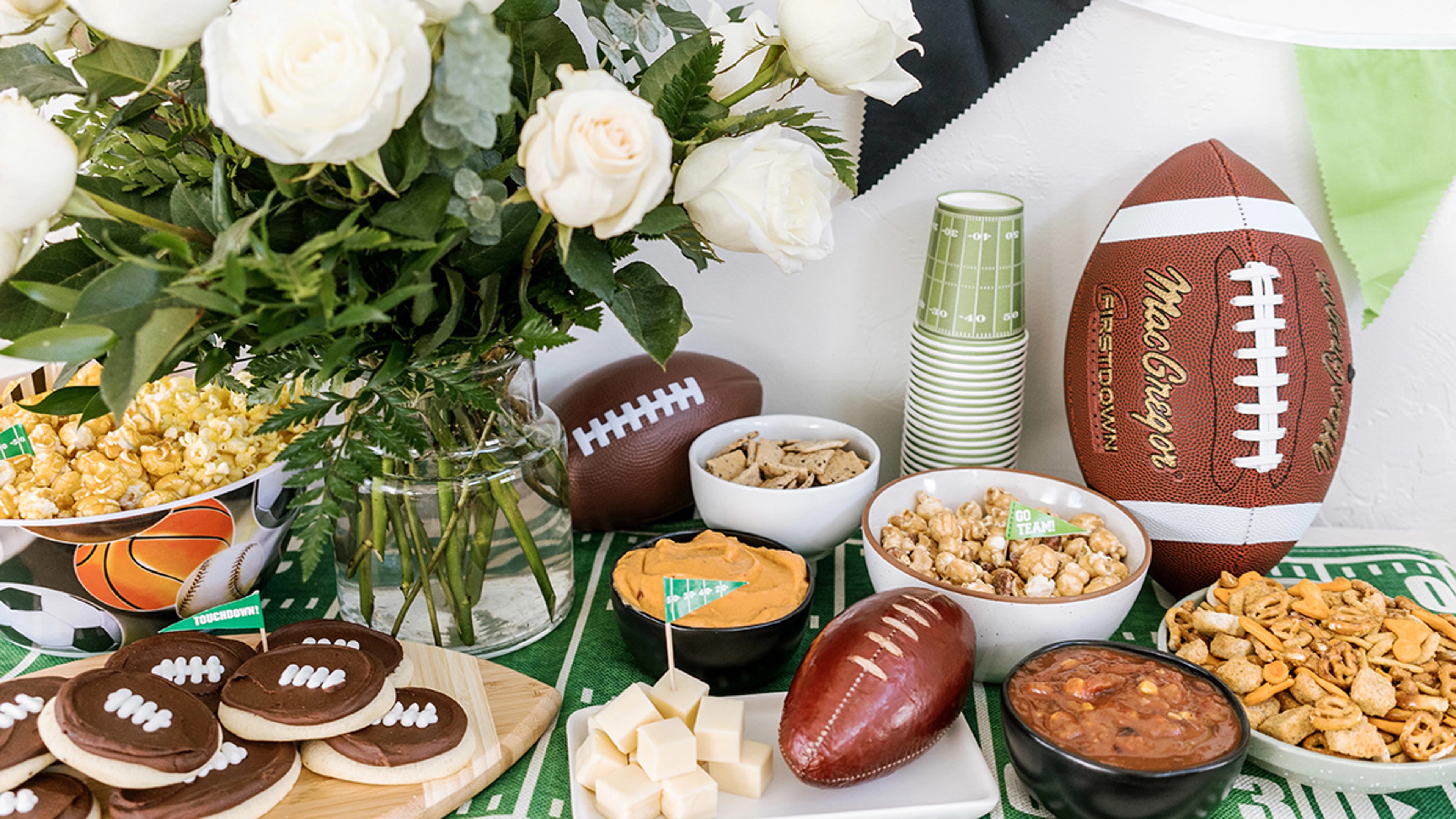 Table laid with tailgate themed snacks and treats.