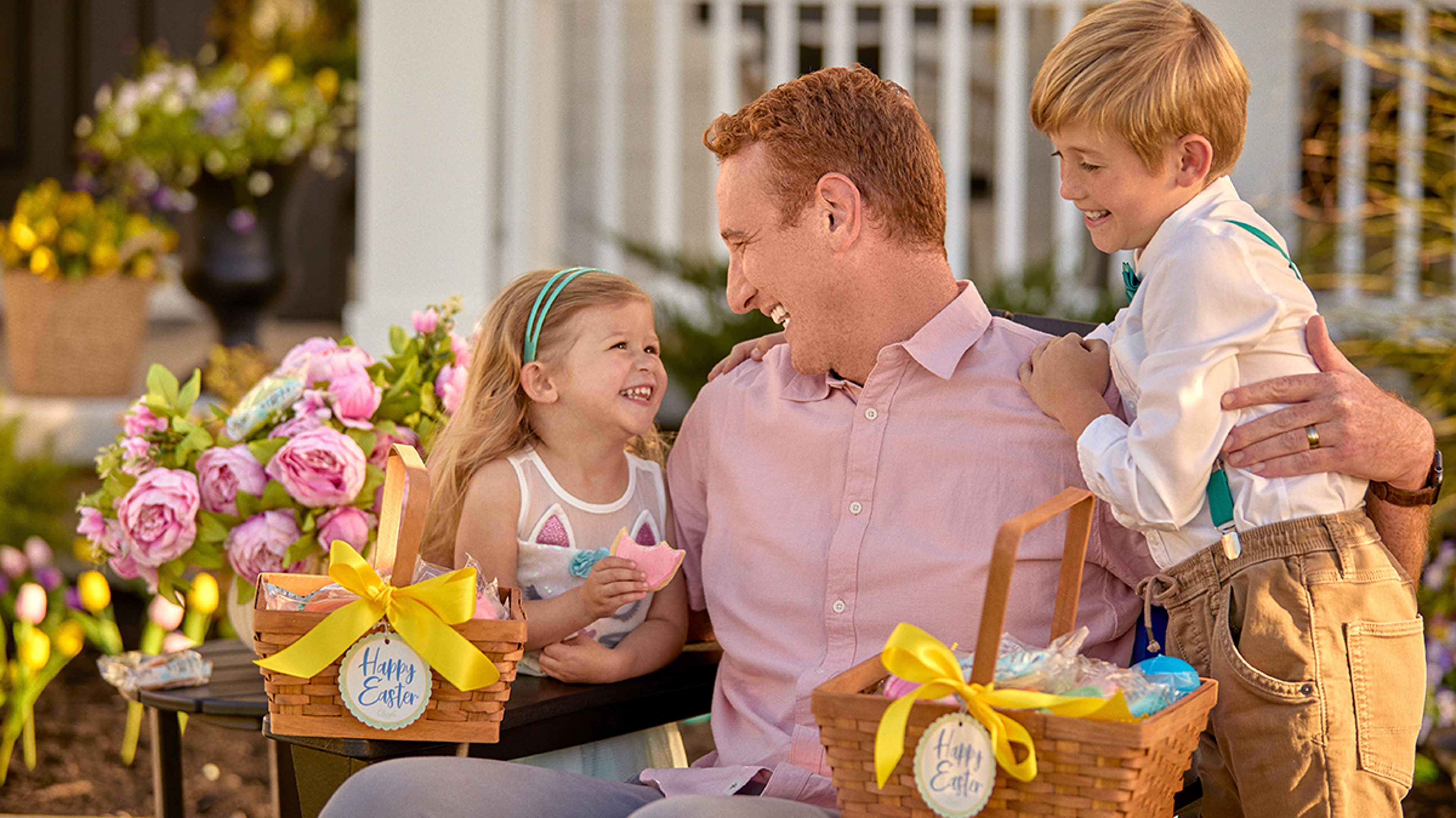 Family doing an Easter egg hunt outside.