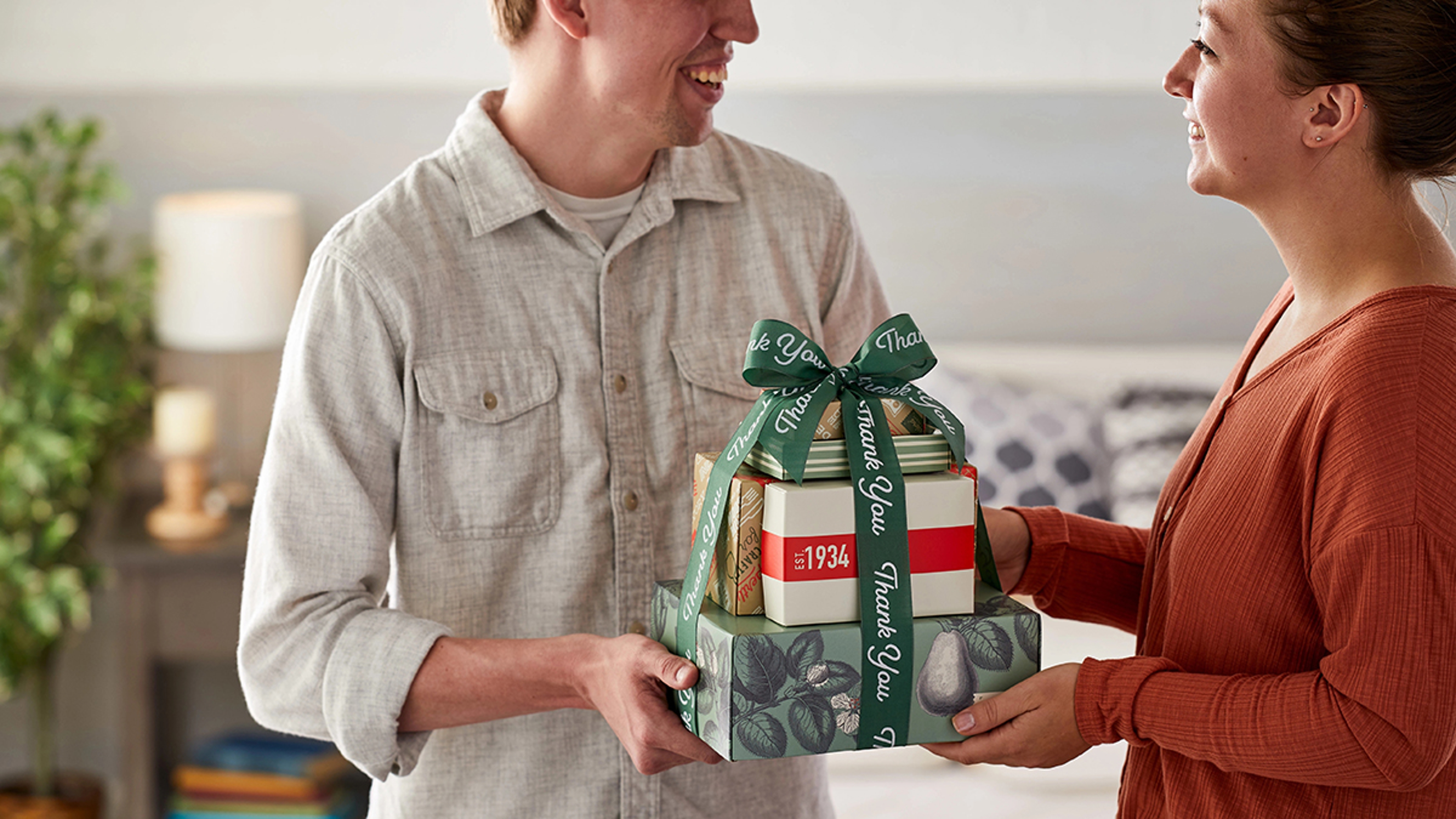 A photo of International Women's Day with a man giving a woman a thank you gift.