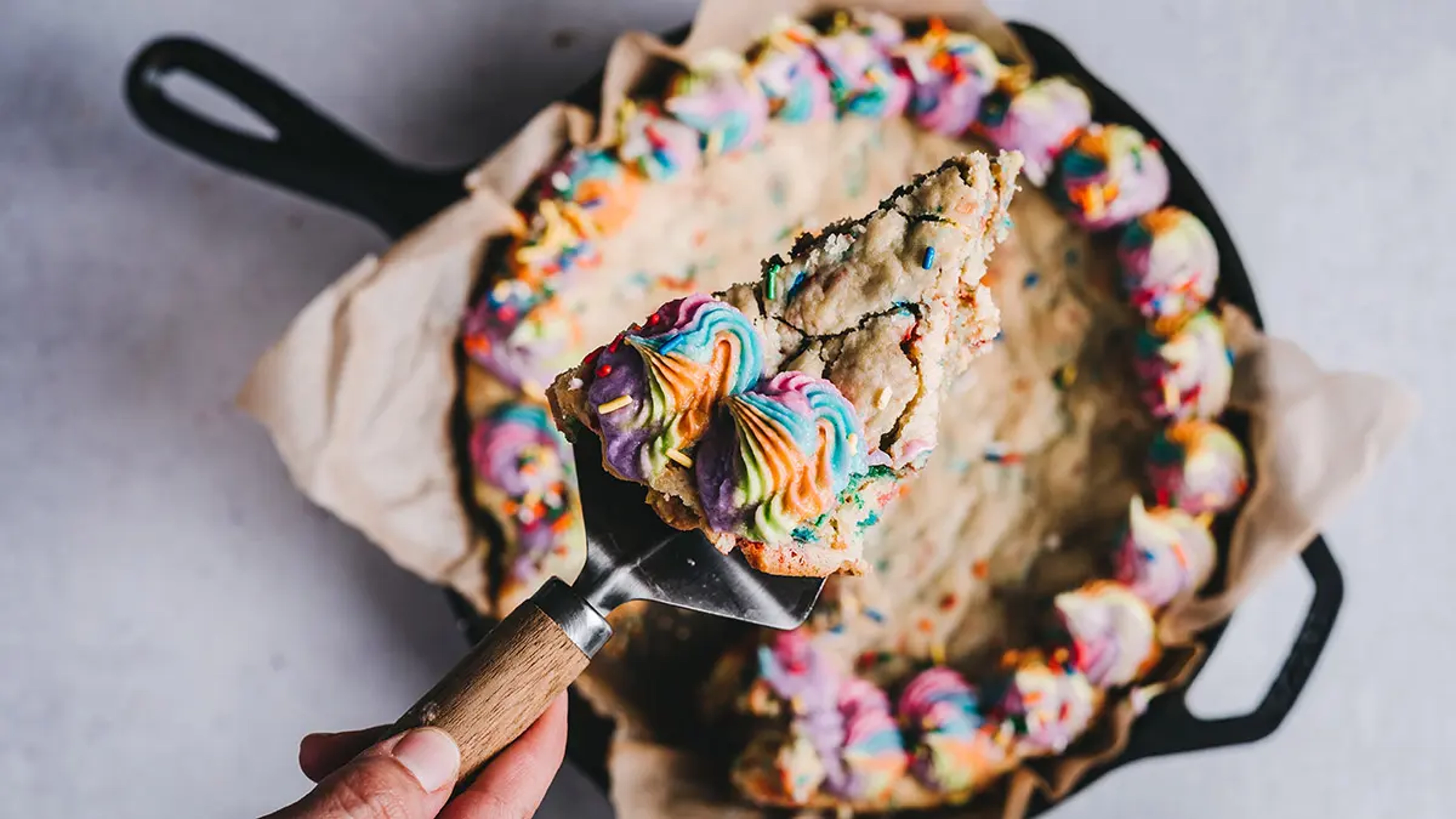 Cheryl's Cookies cookie cake with rainbow sprinkles and rainbow icing