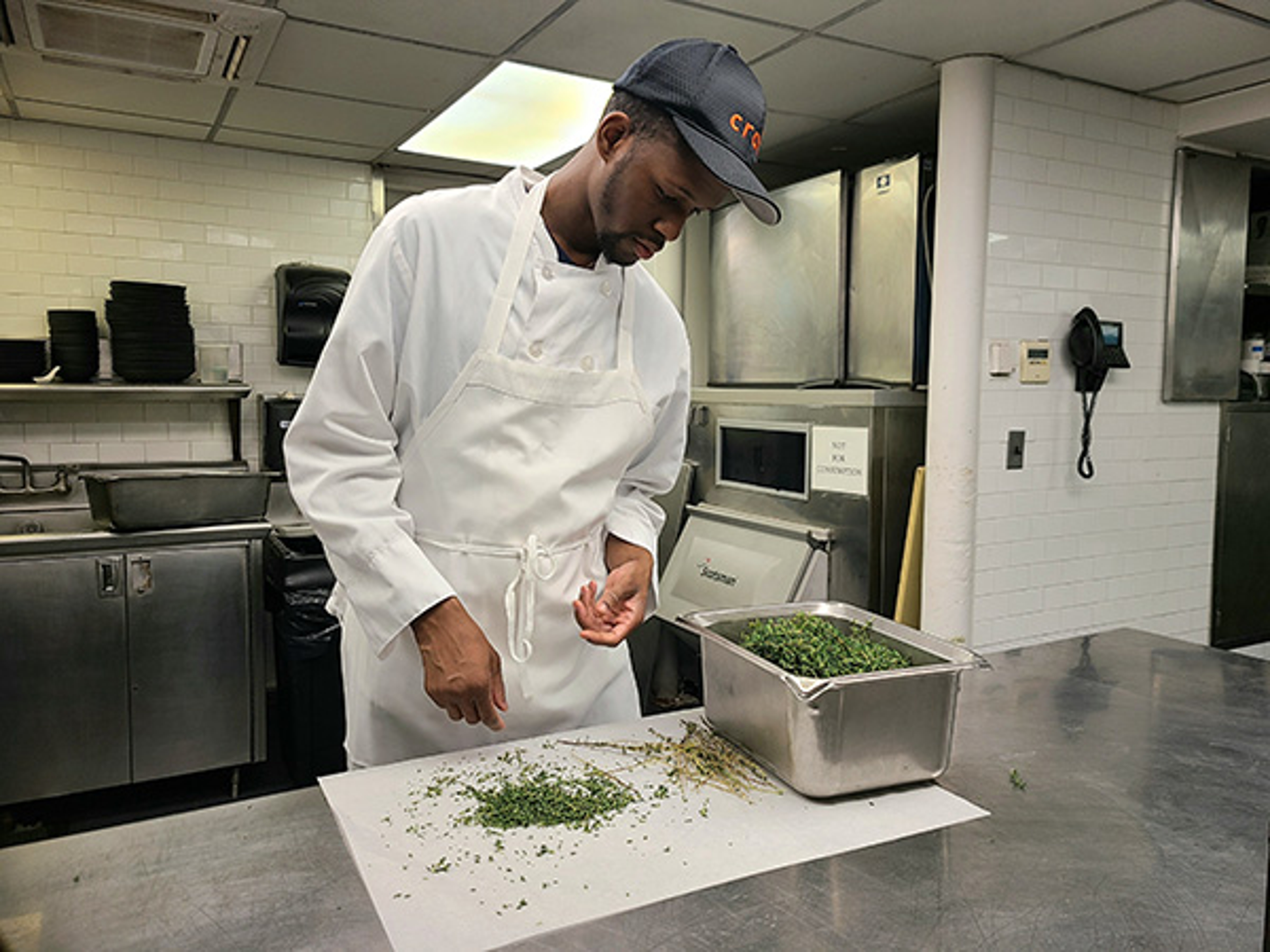 Photo of Manny Irick in the kitchen of restaurant. He was hired through Smile Farms, which helps createjobs for people with disabilities