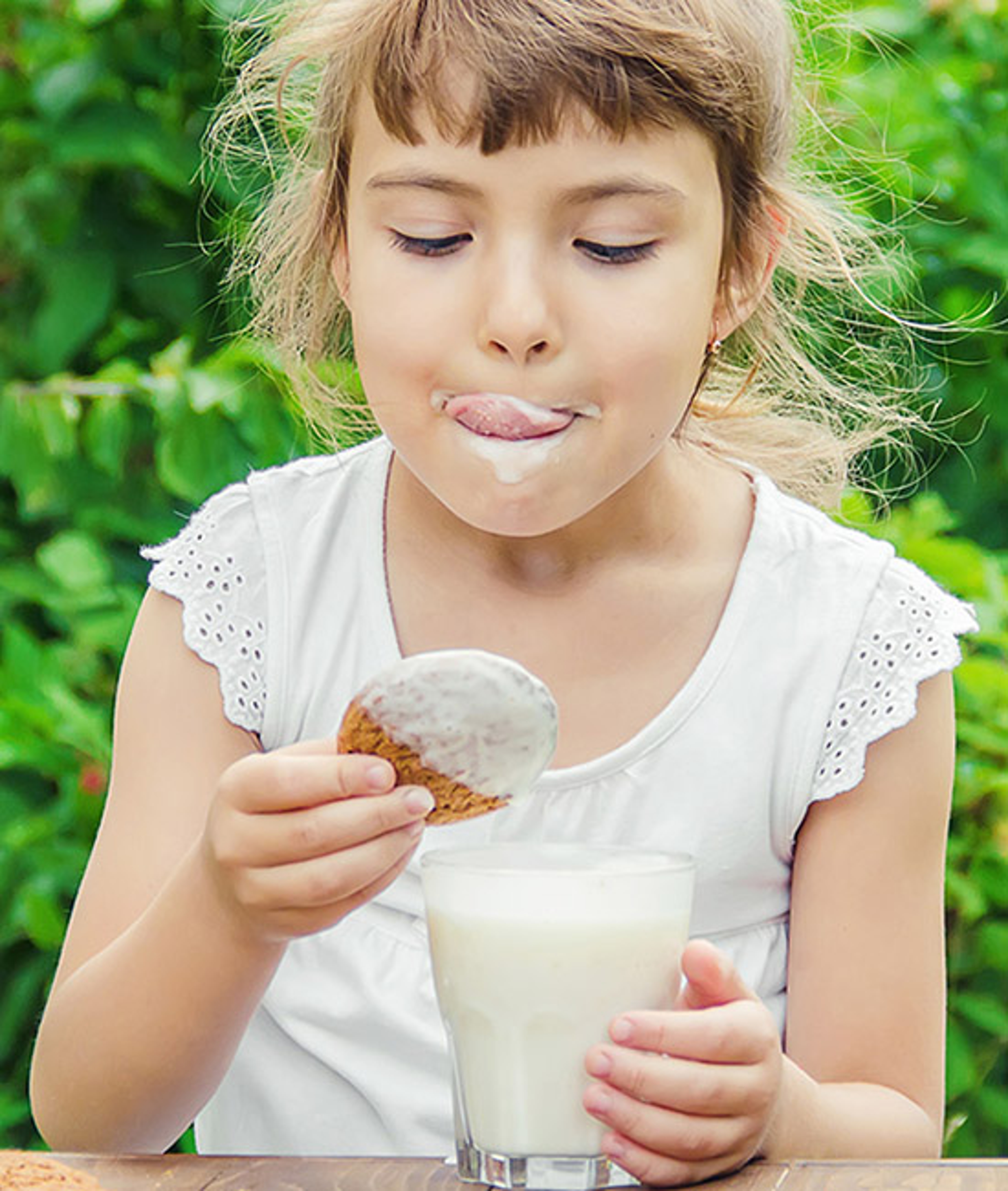 food nostalgia girl enjoying cookies and milk