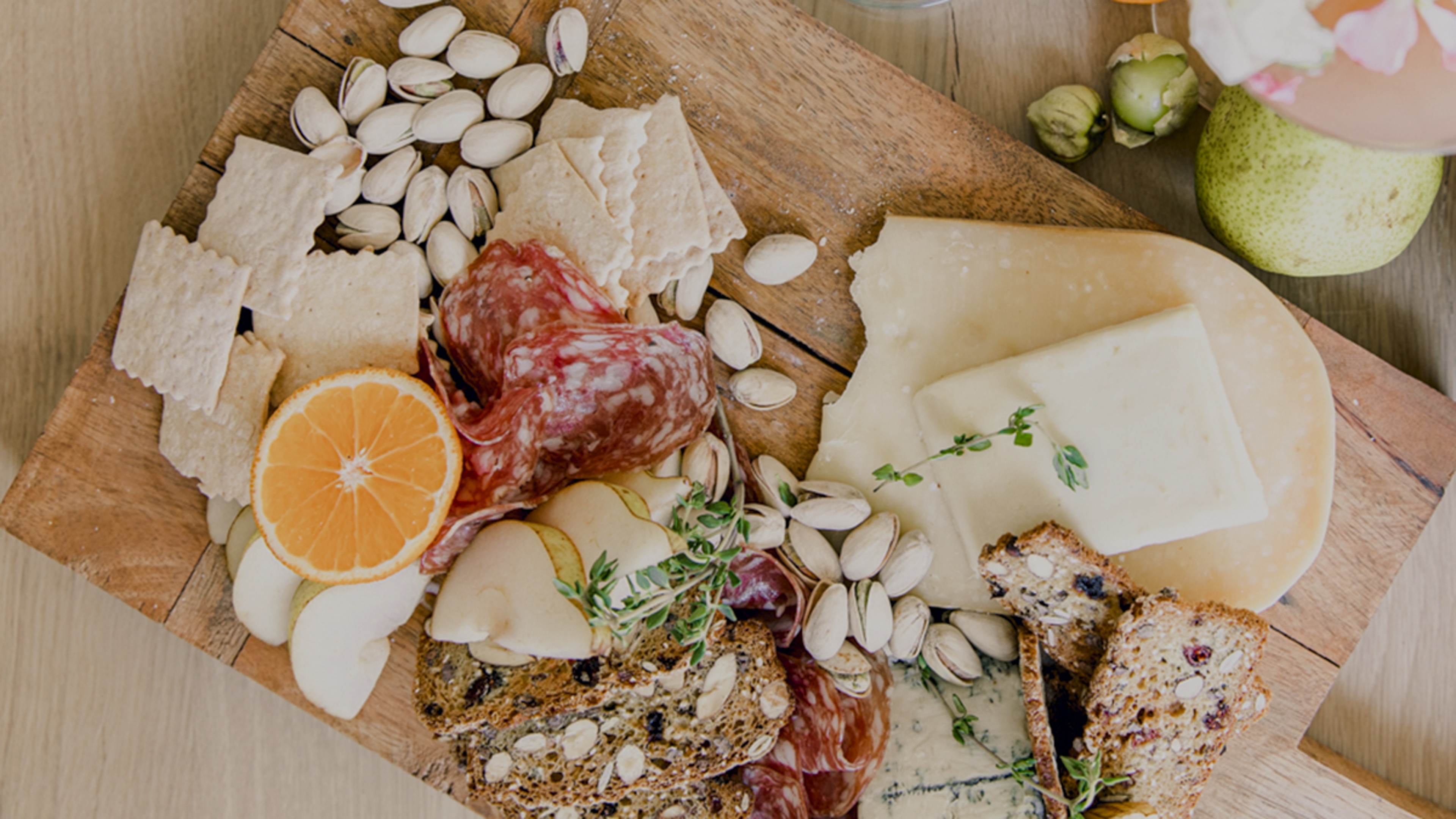 how to host a baby shower charcuterie board with crackers, fruit, cheese and meat.