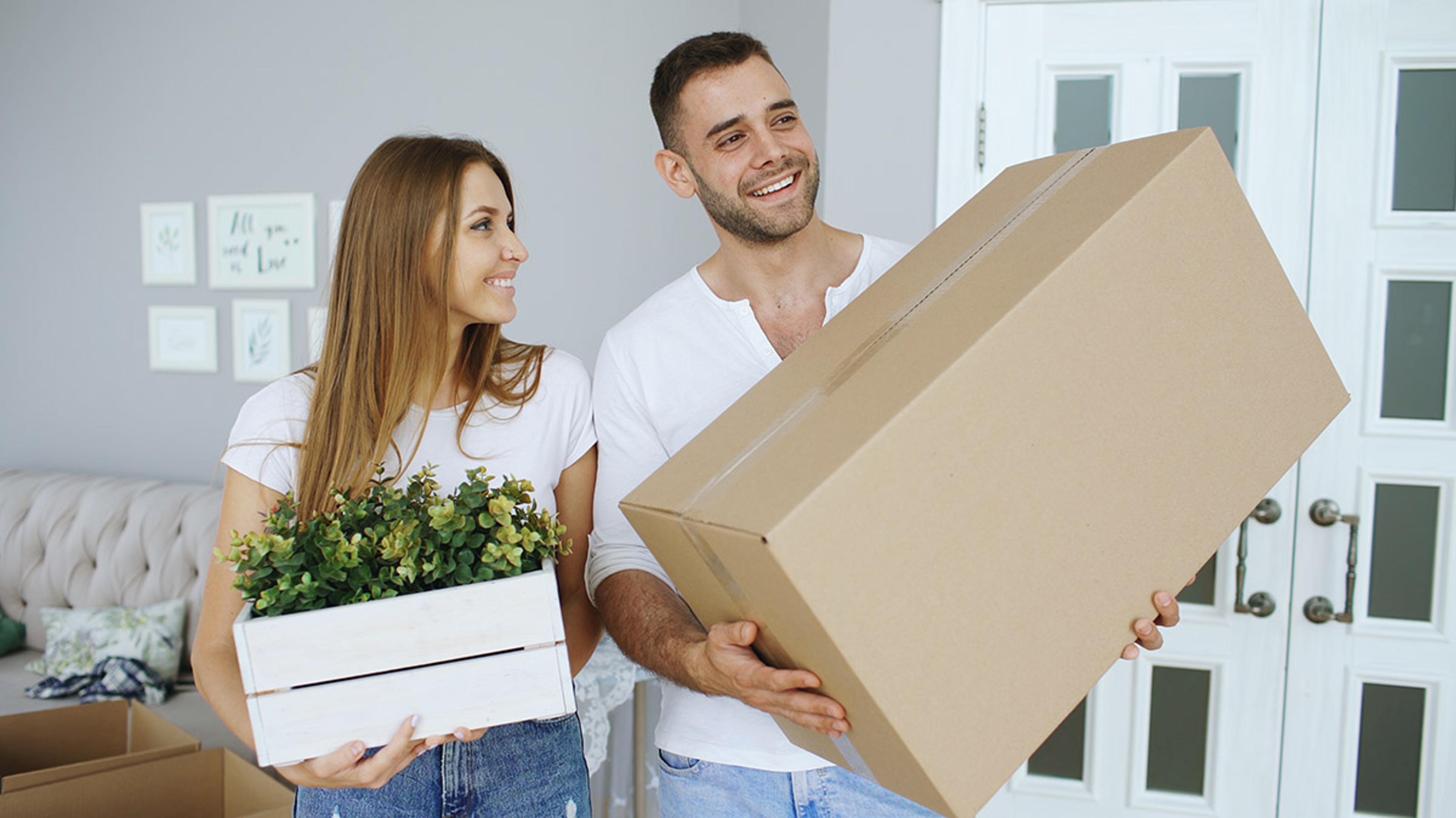 gifts for new homeowners couple moving in holding box and plant