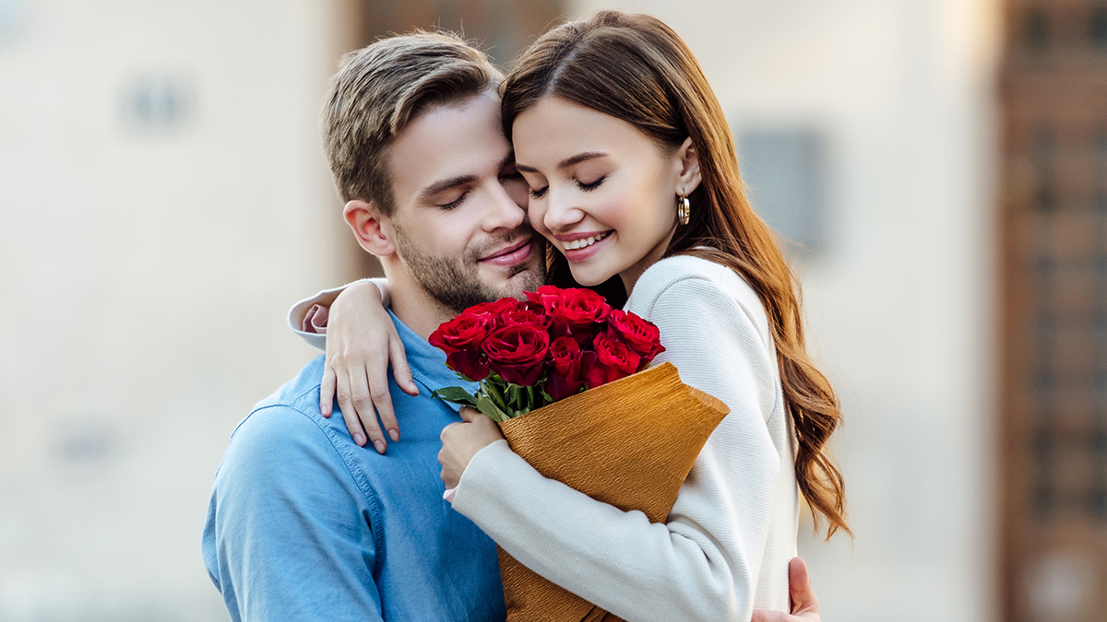 Article Cards Featured Image panoramic shot of woman embracing boyfriend while holding bouquet of roses