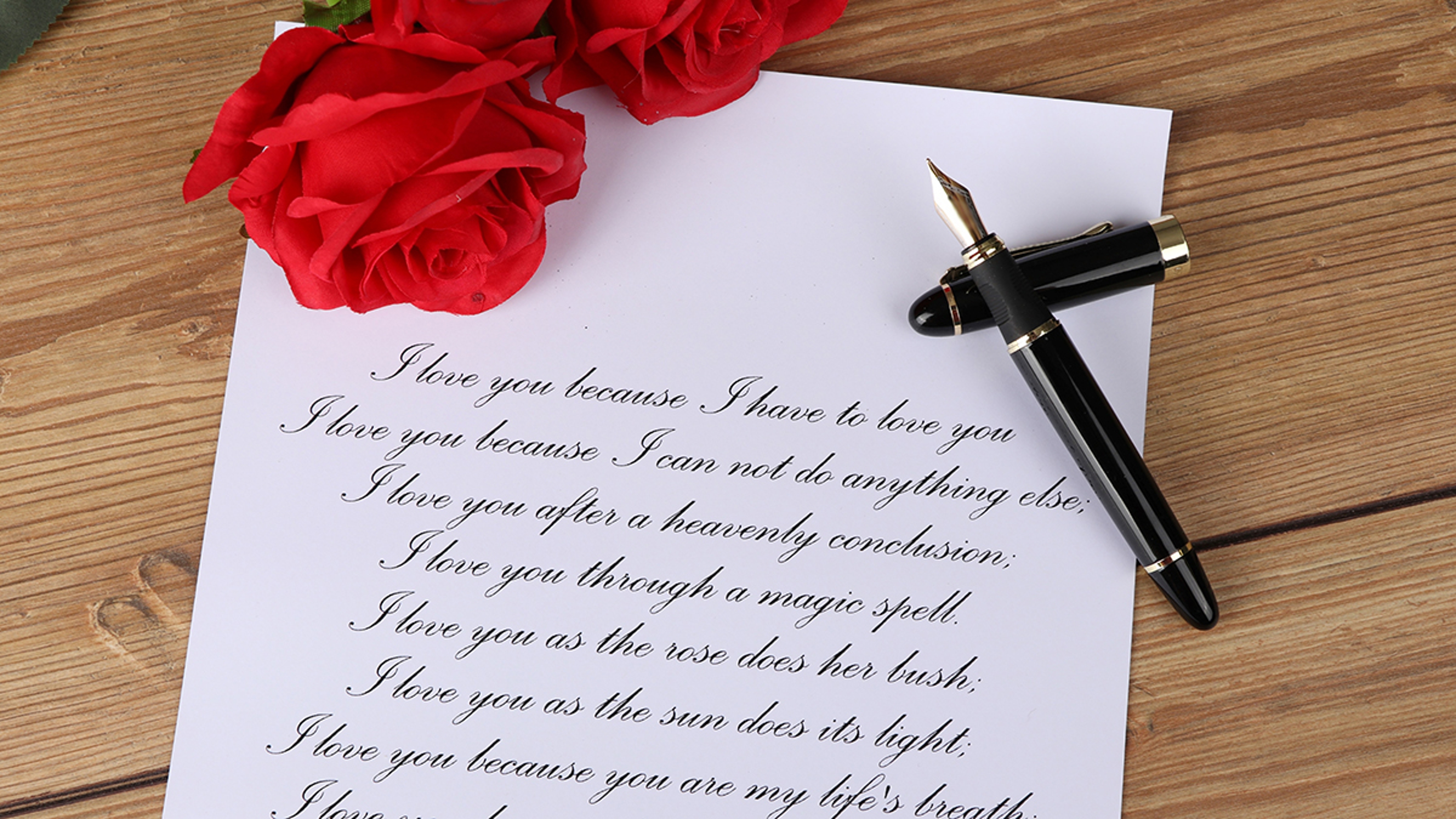 Article Cards Featured Image A photo showing a love poem with a fountain pen and roses