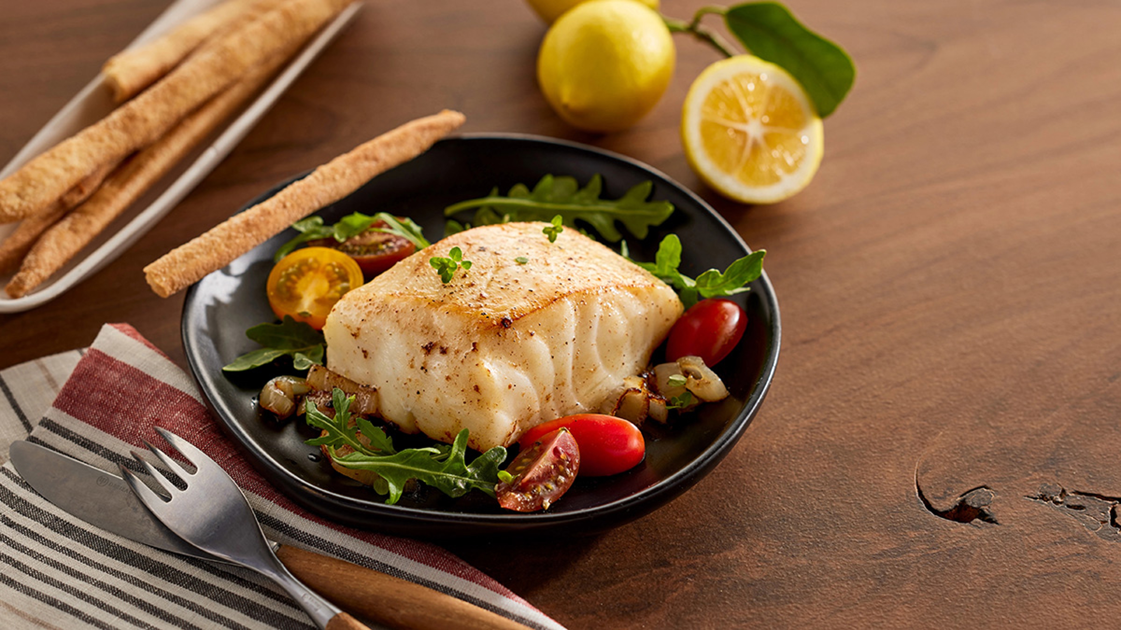 Filet of Chilean seabass plated with vegetables.