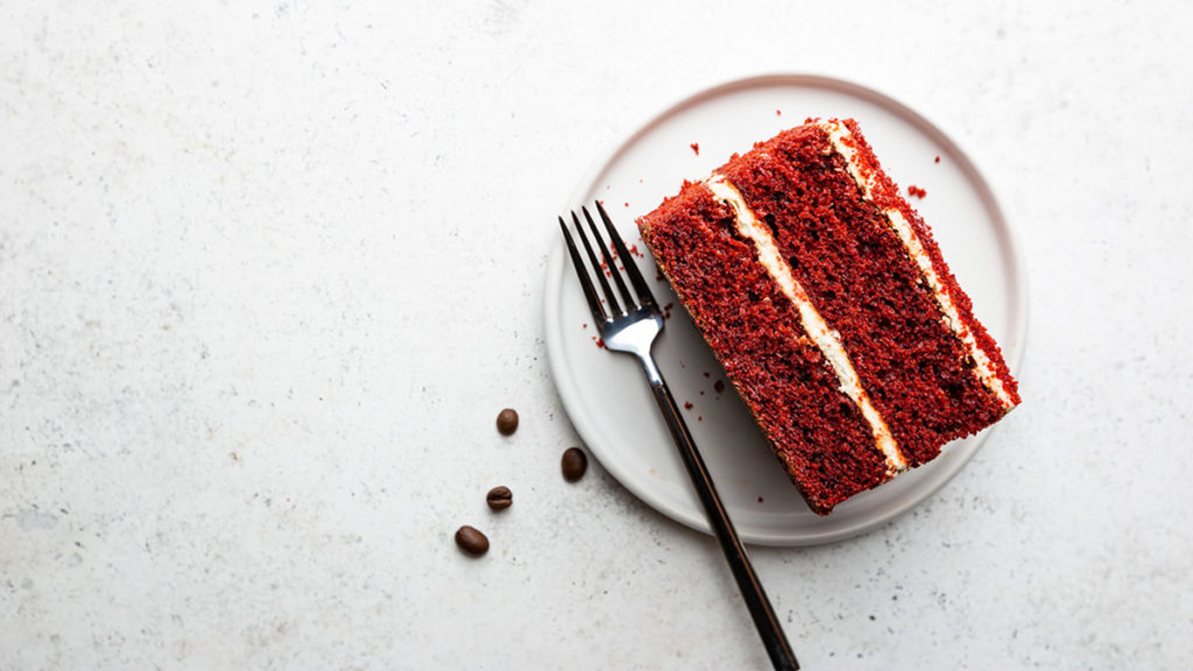 Slice of red velvet cake on a plate.