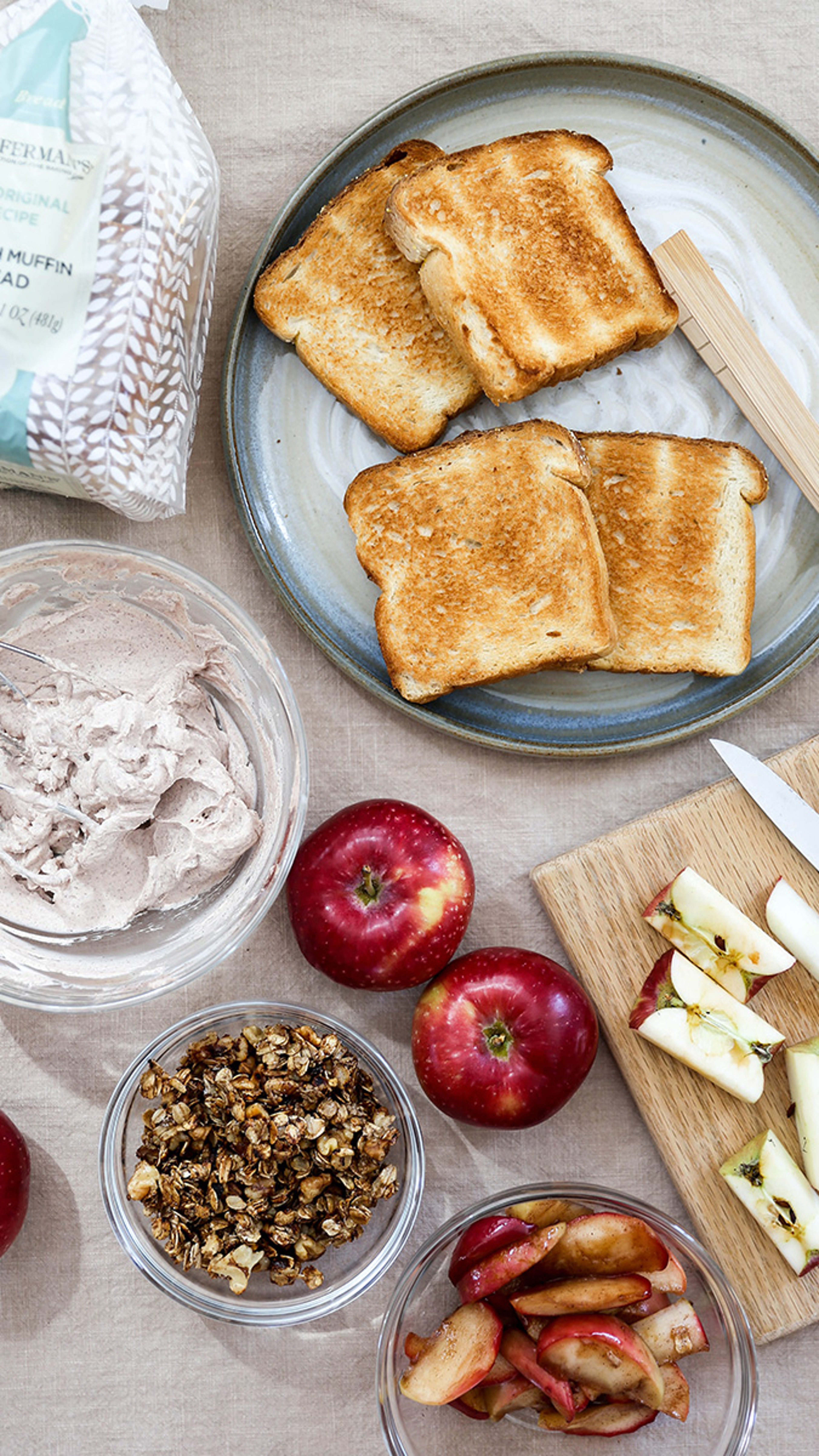 Toasted bread for apple crisp toast with ingredients surrounding it.