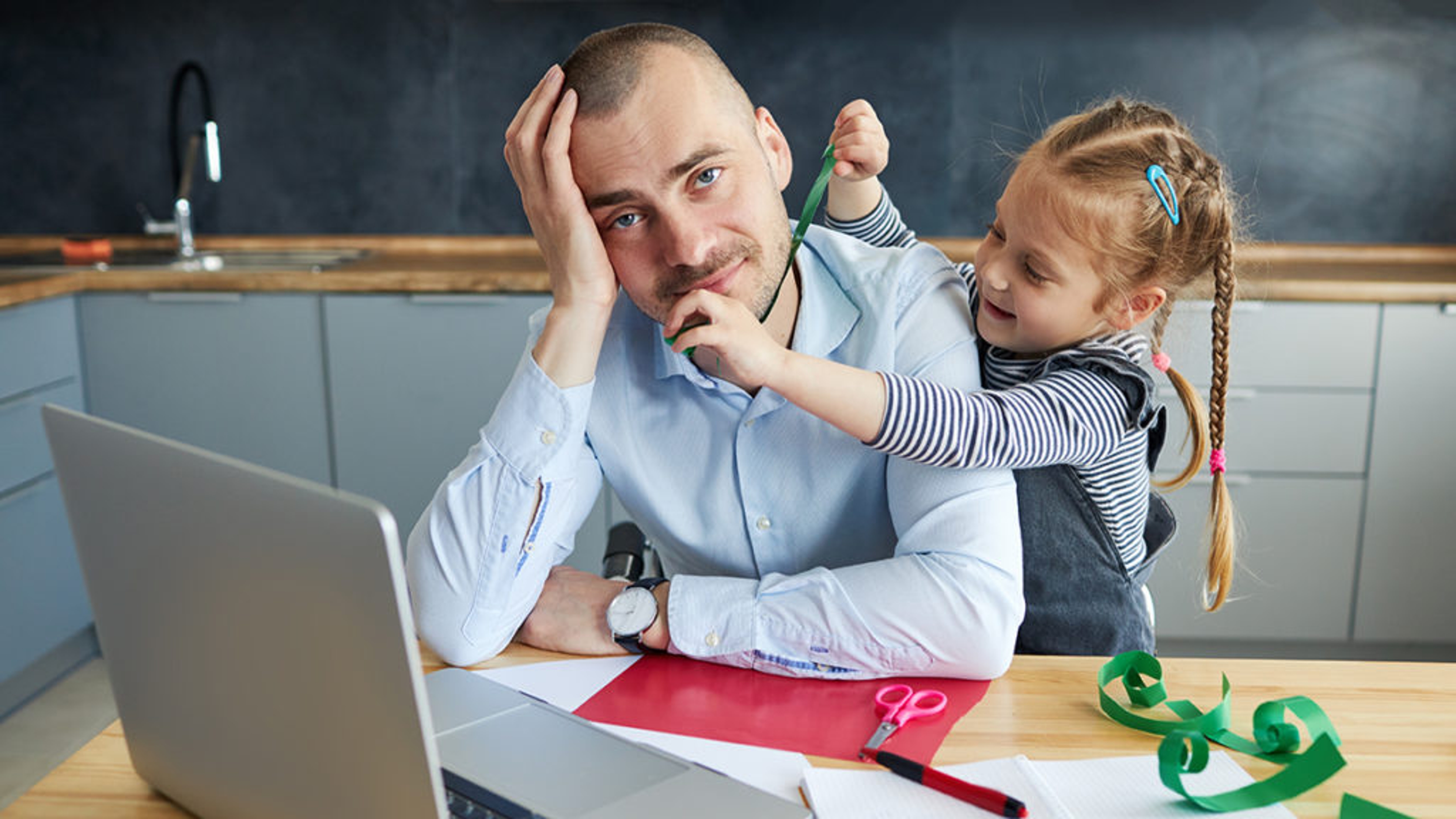 dadd brain man sitting as desk with child pestering him