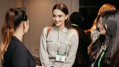 Three young women talking with each other at an IAPP conference