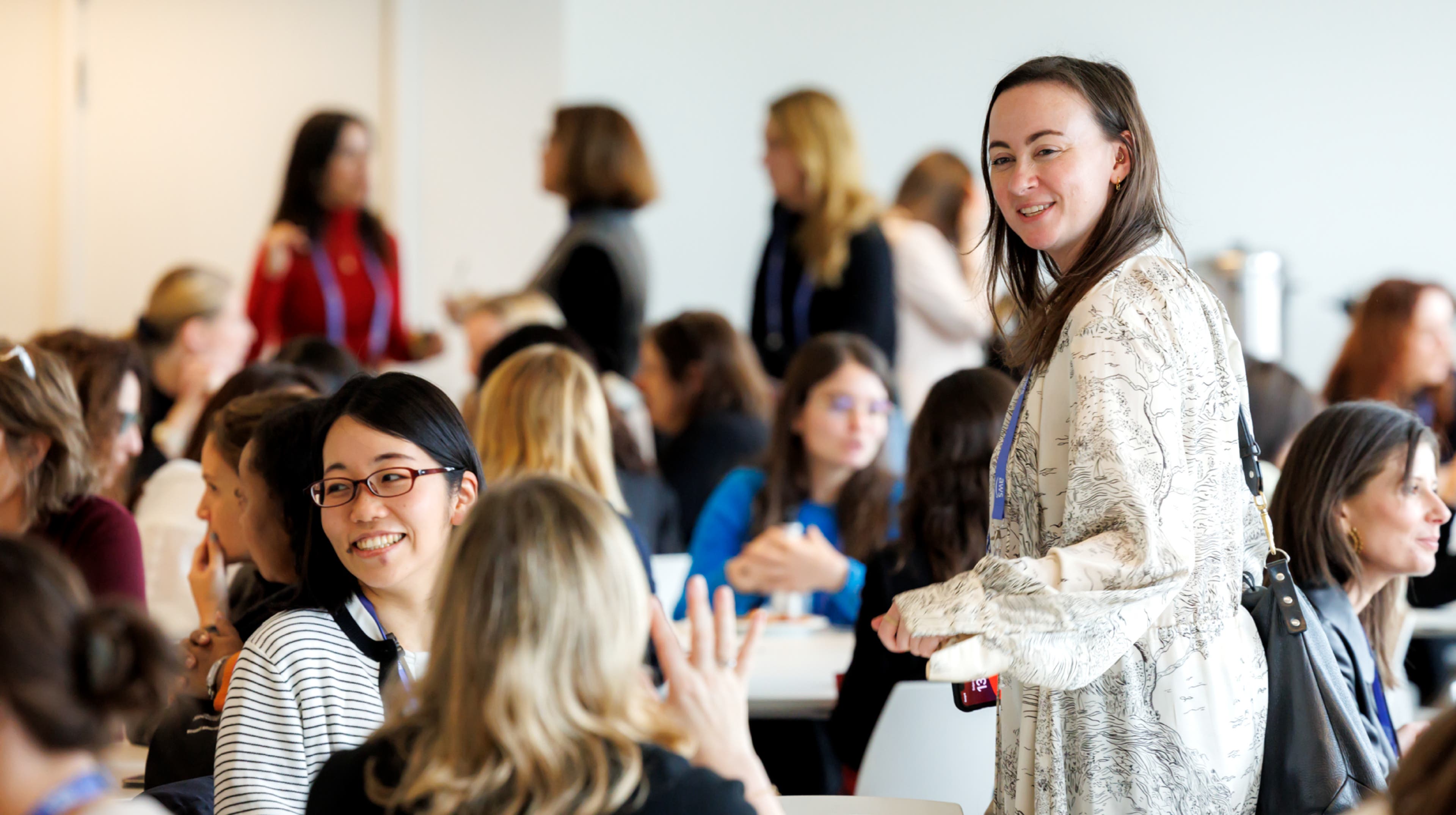A woman speaking at a microphone at a conference