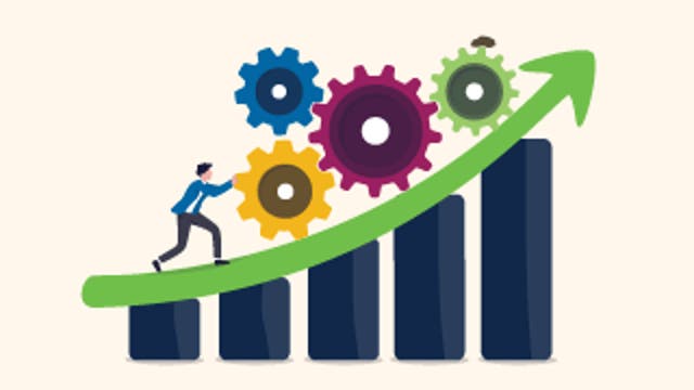 Person pushing colorful gears up a rising bar chart with a green arrow, symbolizing progress.