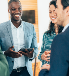 three people standing and talking at networking event