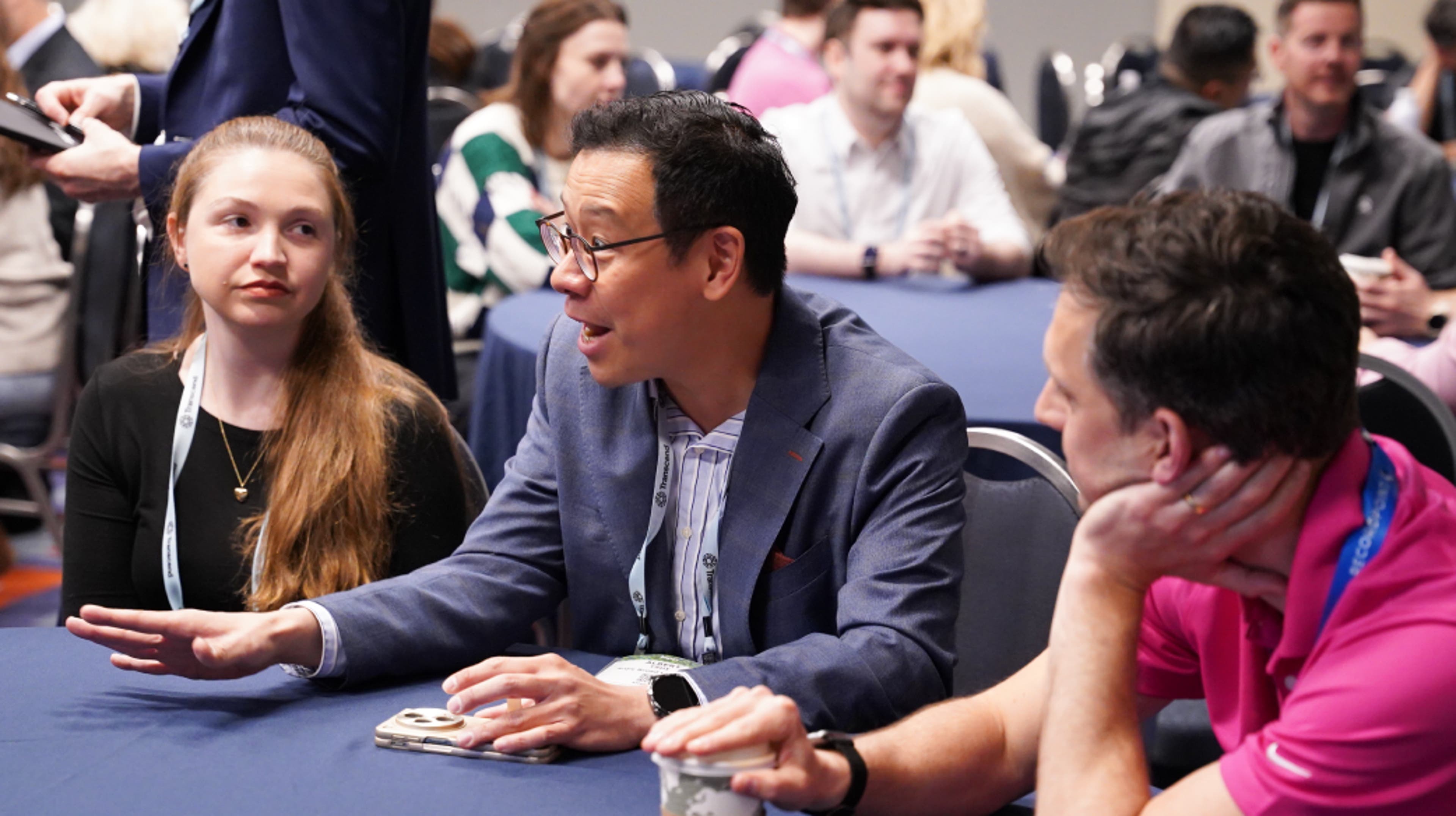 three people standing and talking at networking event