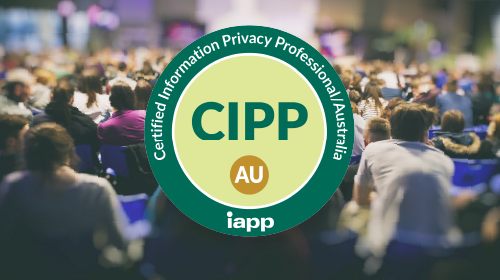 A green circular IAPP certification badge reading Certified Information Privacy Professional/Australia with the acronym CIPP/AU in the center, displayed over a blurred background of conference attendees seated in a large audience.