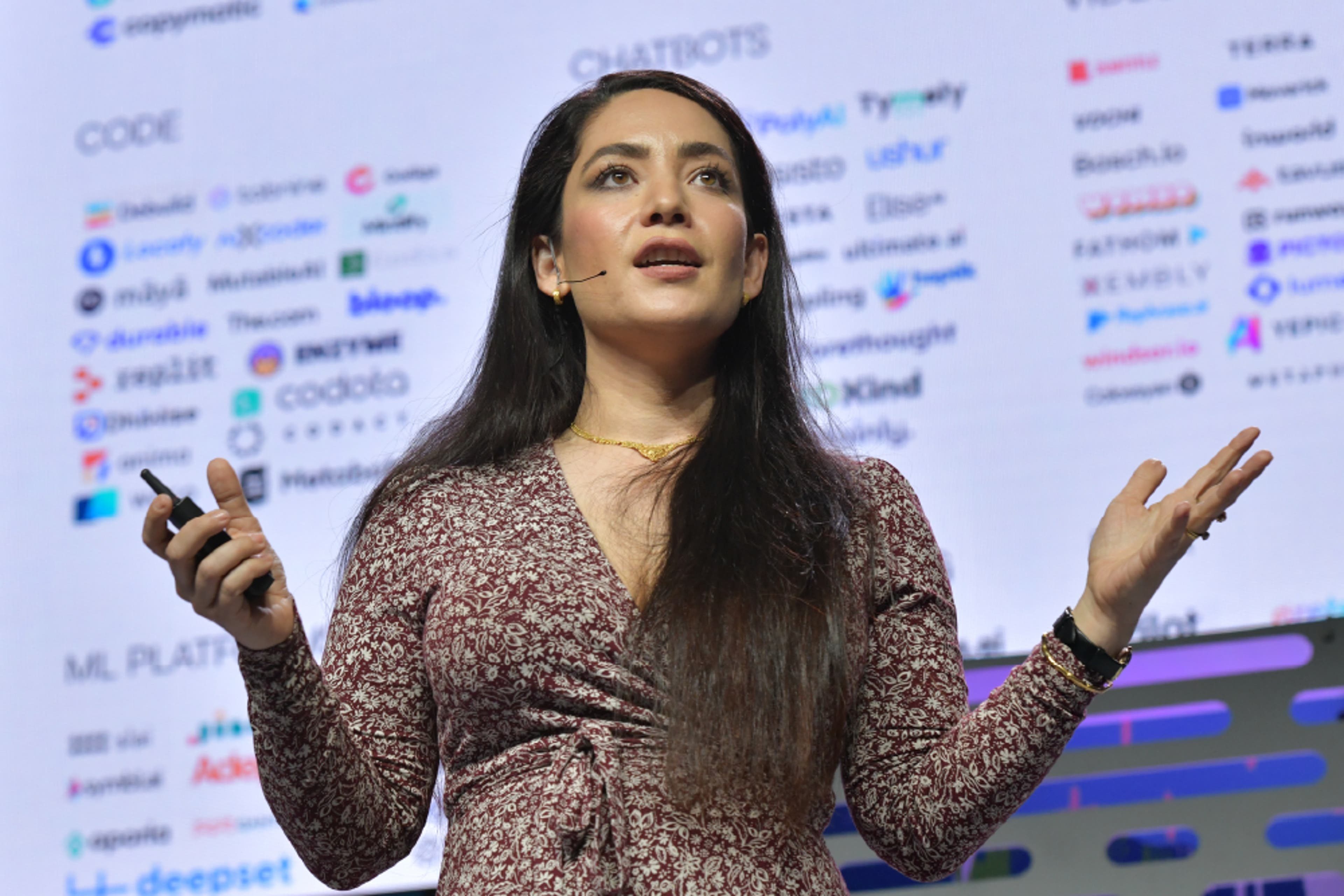 A man with partially gray hair and a beard wearing a sport coat with his arms crossed. He is smiling.