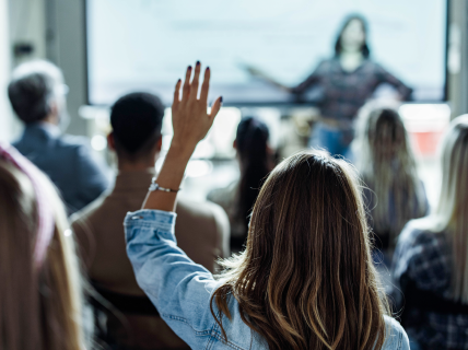 woman raising hand in live-taught class